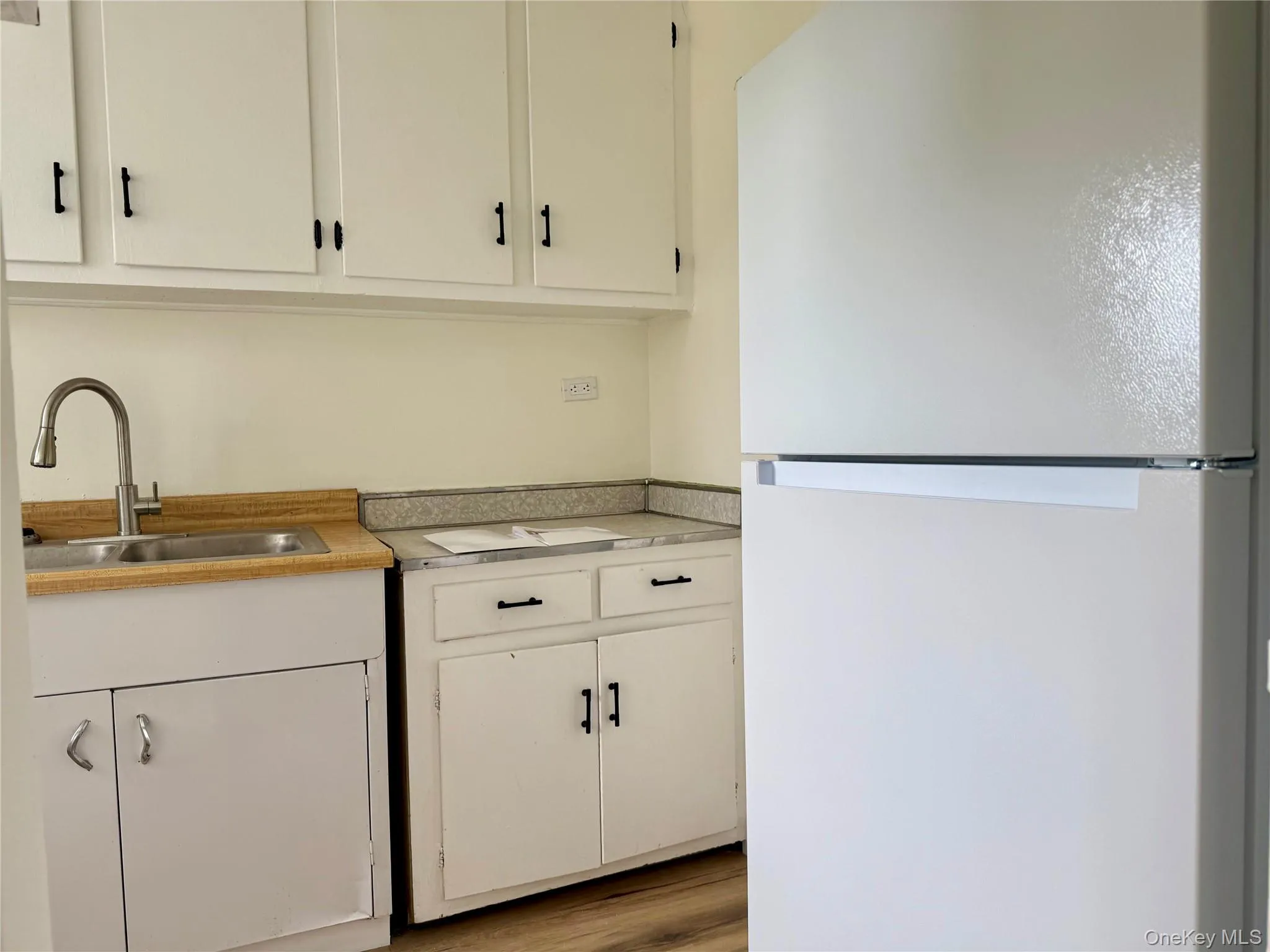 Kitchen with original wood cabinets, stainless steel sink, plenty of cabinets, large window for ventilation. Kitchen with original wood cabinets, stainless steel sink, plenty of cabinets, large window for ventilation.