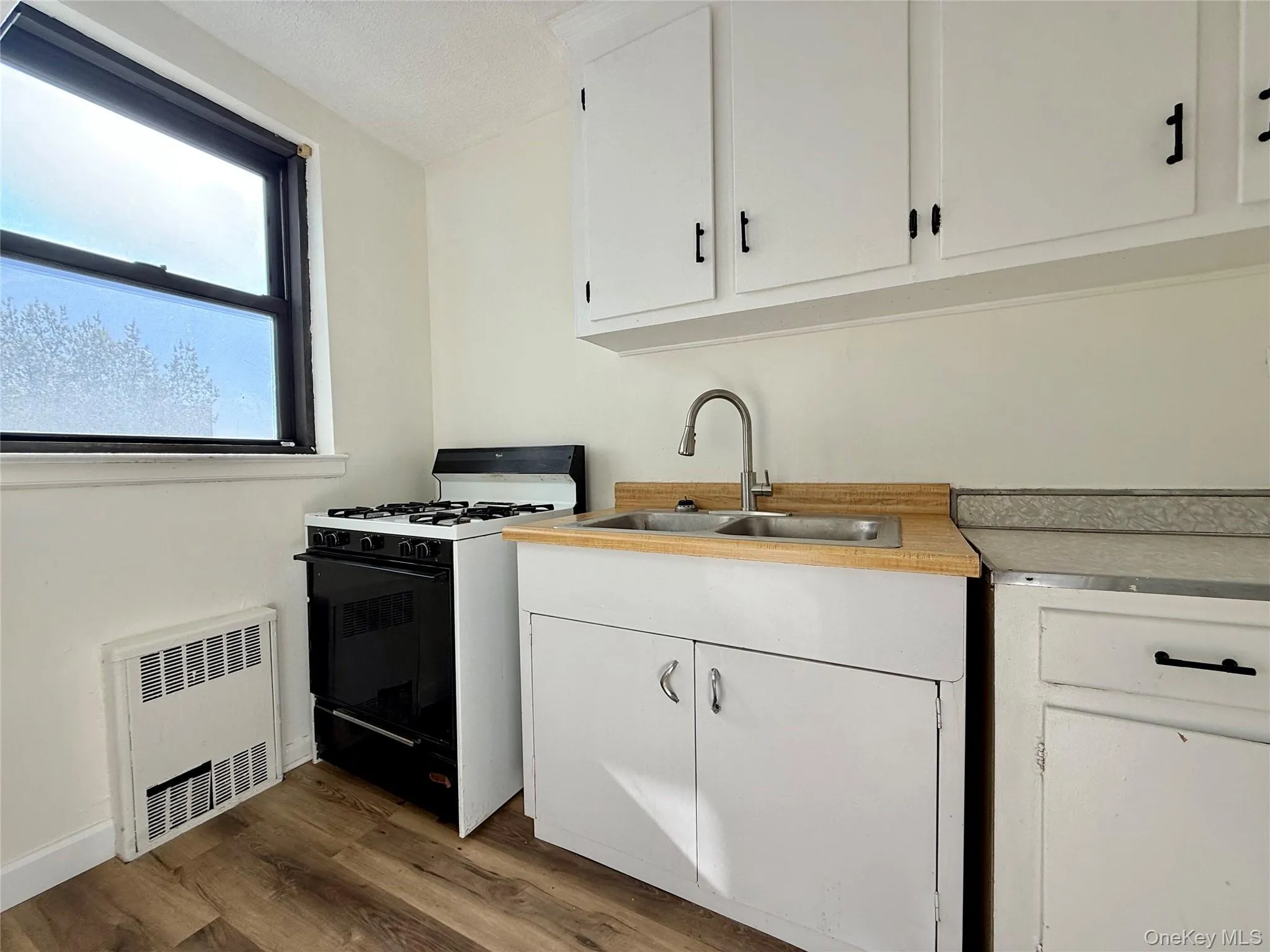 Kitchen with original wood cabinets, stainless steel sink, plenty of cabinets, large window for ventilation. Kitchen with original wood cabinets, stainless steel sink, plenty of cabinets, large window for ventilation.