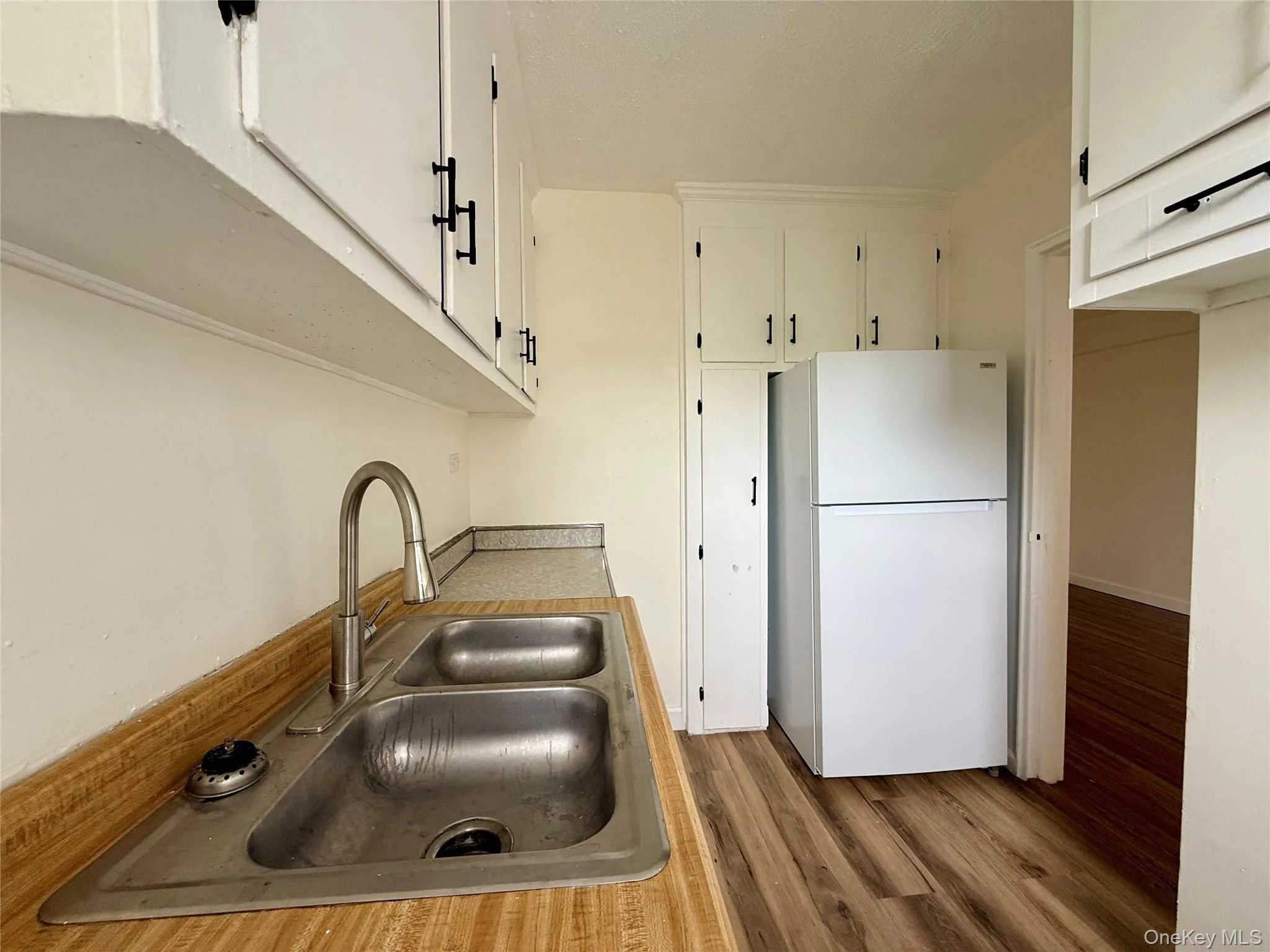 Kitchen with original wood cabinets, stainless steel sink, plenty of cabinets, large window for ventilation. Kitchen with original wood cabinets, stainless steel sink, plenty of cabinets, large window for ventilation.