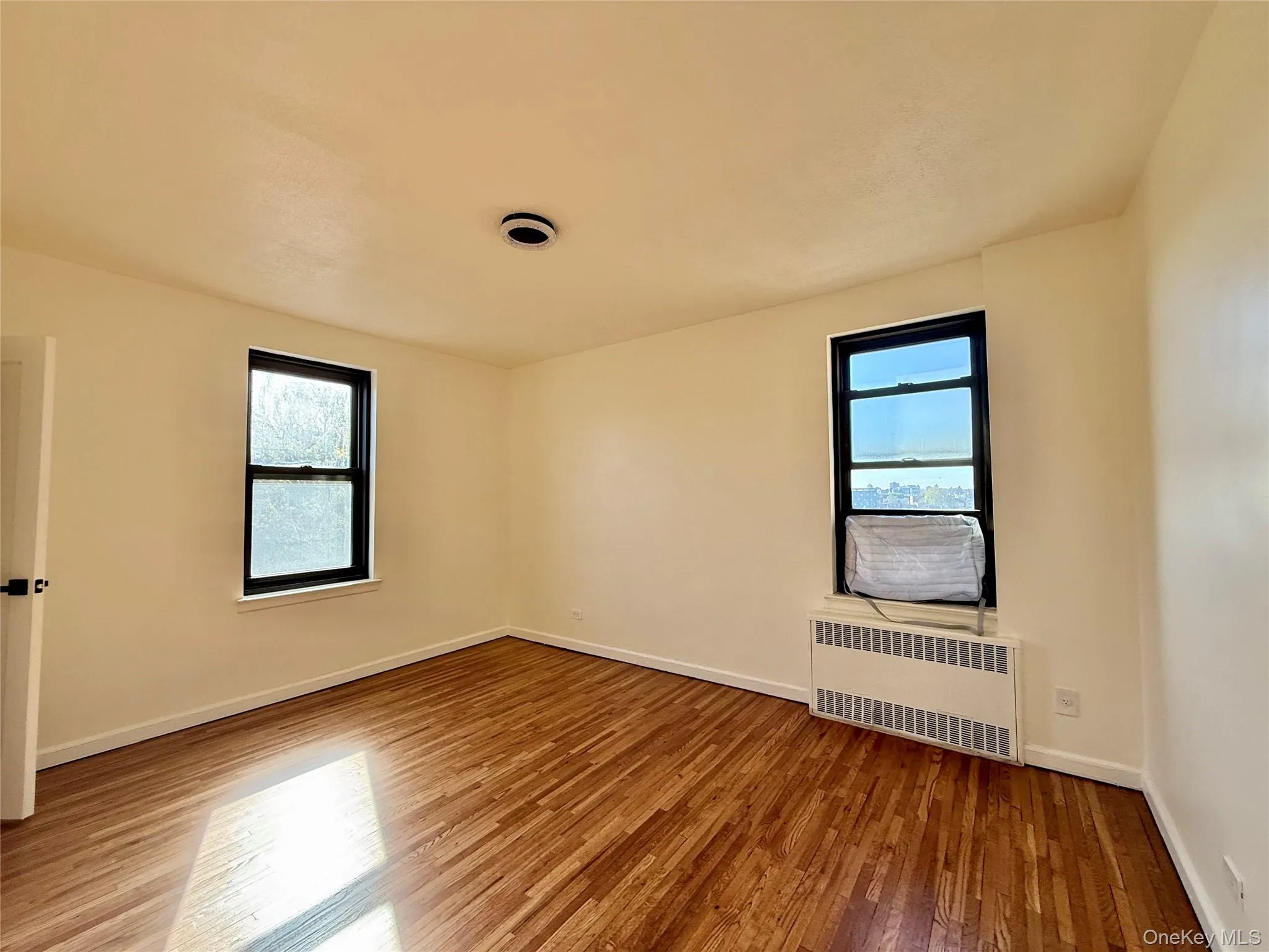 Corner bedroom with 2 opposite side windows, 2 closets. Ceiling light, hardwood floors. Great view of Cityfield Corner bedroom with 2 opposite side windows, 2 closets. Ceiling light, hardwood floors. Great view of Cityfield