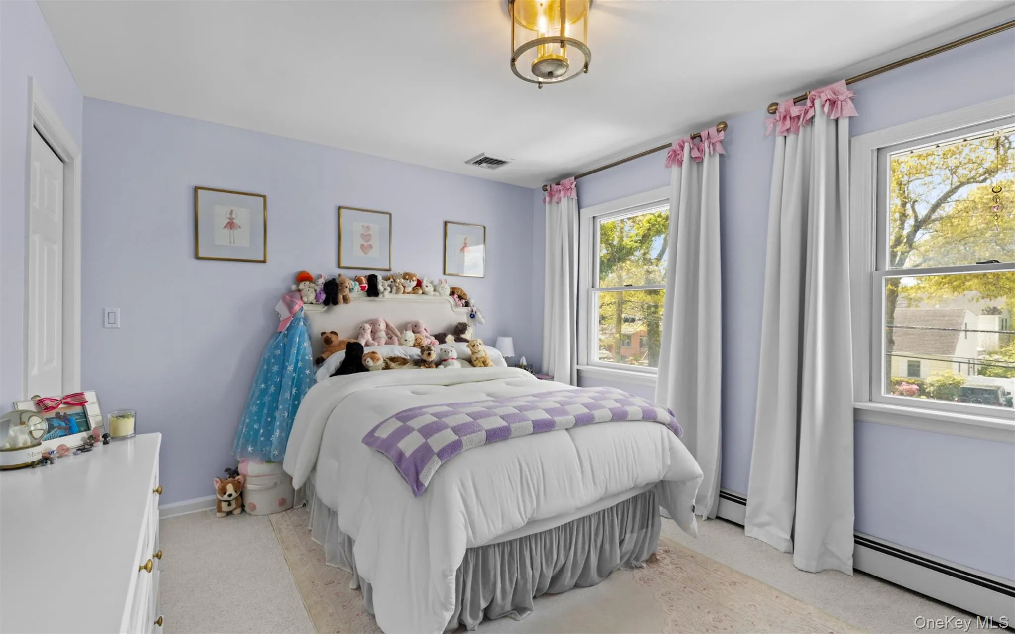 Second floor bedrooom featuring two double-hung windows, a ceiling-mounted light fixture, and light-colored wall-to-wall carpeting Second floor bedrooom featuring two double-hung windows, a ceiling-mounted light fixture, and light-colored wall-to-wall carpeting