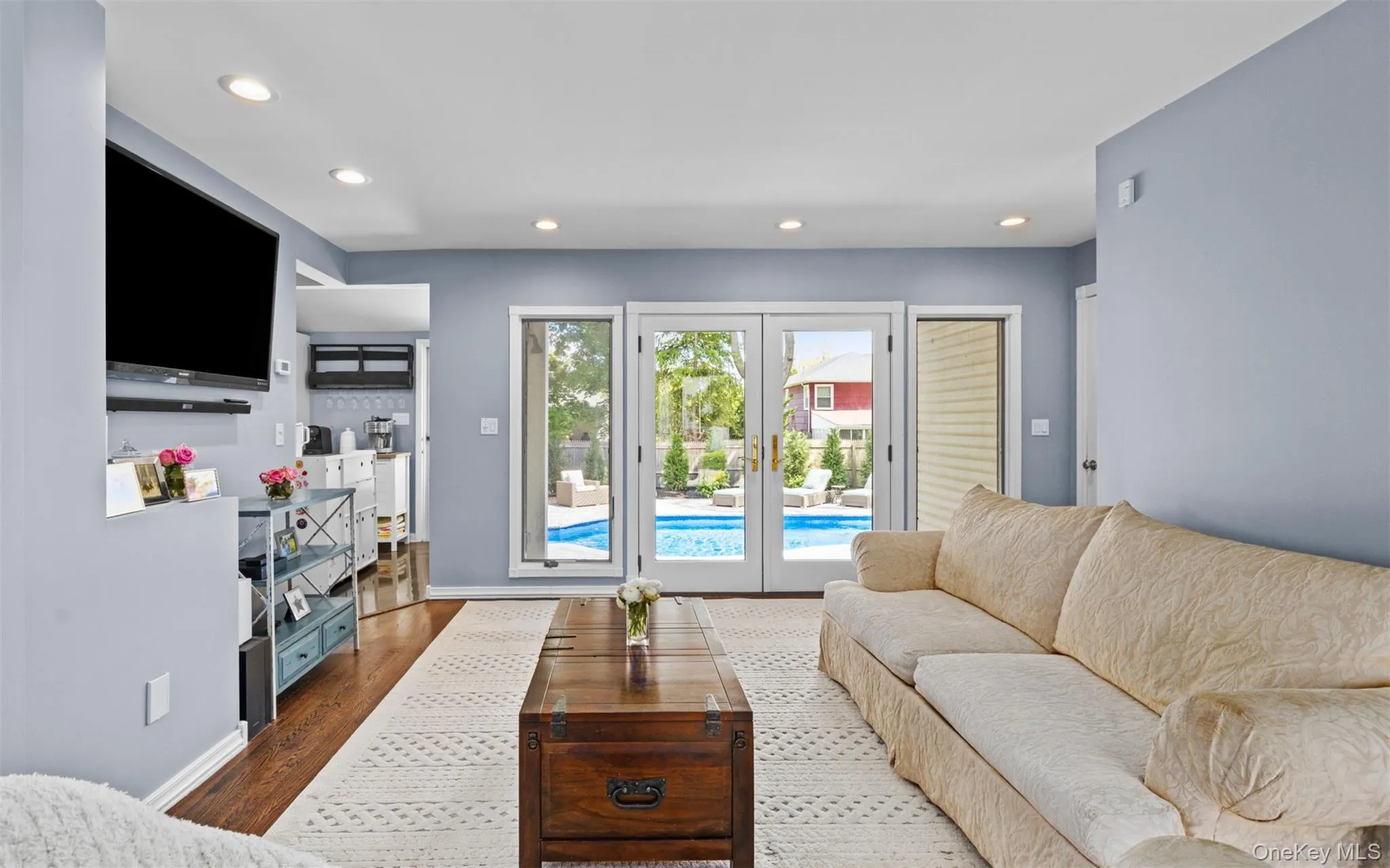 Living room featuring recessed lighting and wood flooring Living room featuring recessed lighting and wood flooring