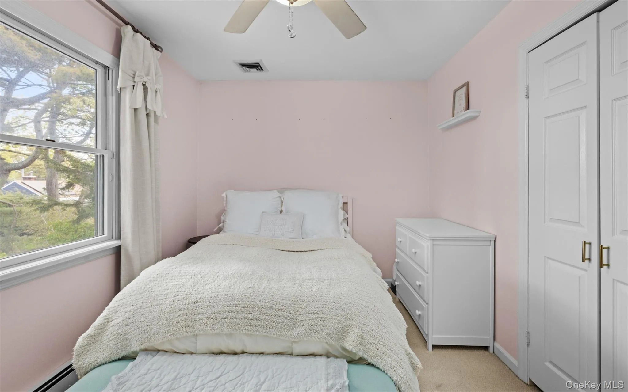 Second floor bedroom featuring a large window window, closet and light-toned carpeting Second floor bedroom featuring a large window window, closet and light-toned carpeting