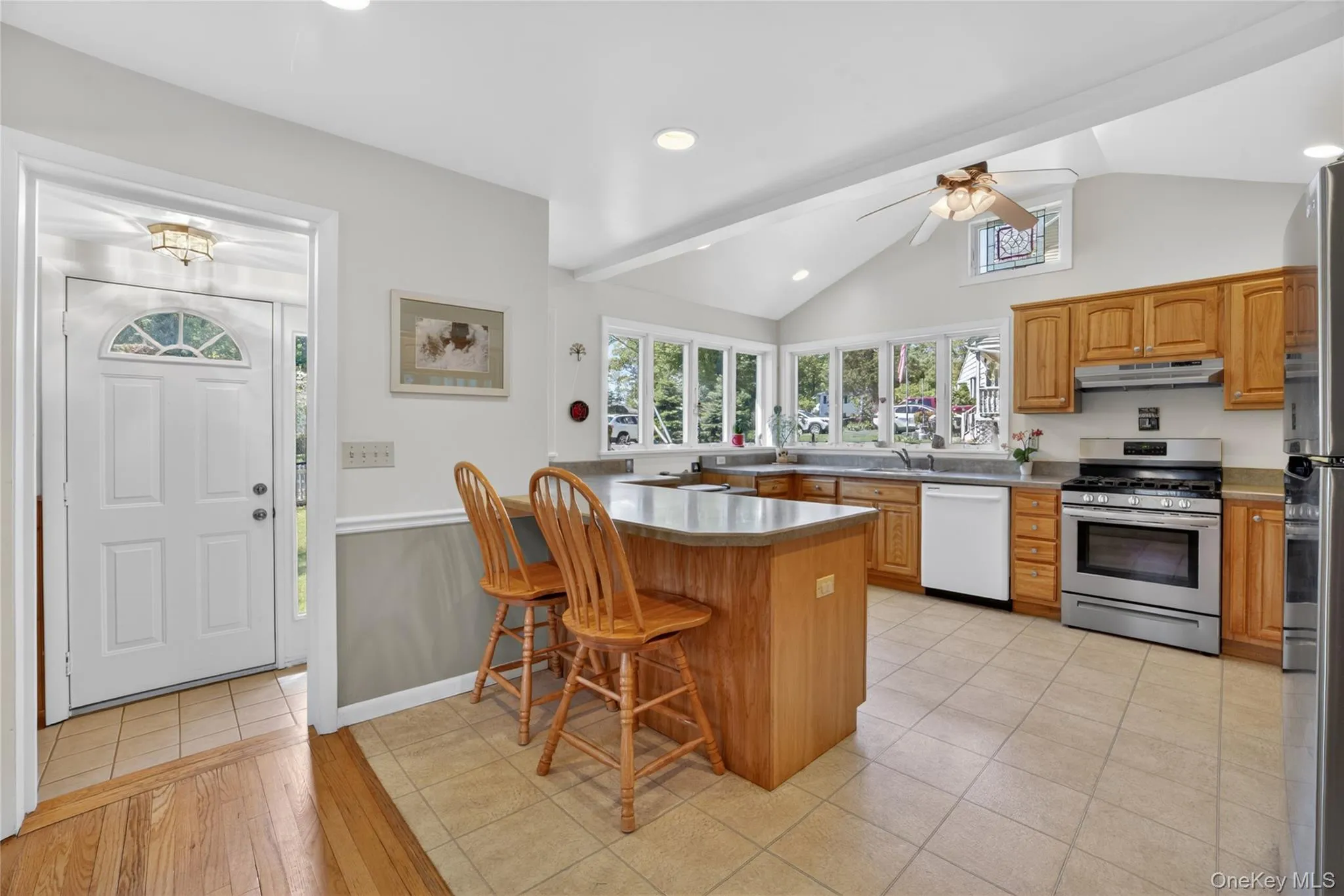 The spacious kitchen with peninsula, stools and a skylight. The spacious kitchen with peninsula, stools and a skylight.