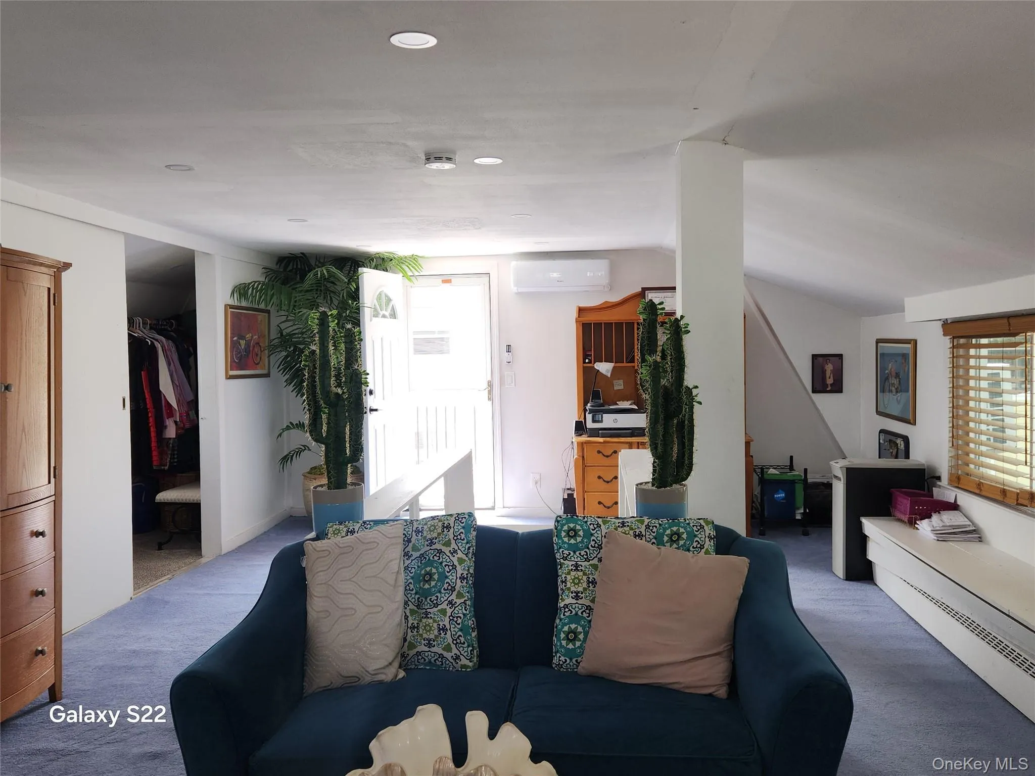Living room featuring a wall mounted air conditioner, carpet flooring, recessed lighting, and vaulted ceiling Living room featuring a wall mounted air conditioner, carpet flooring, recessed lighting, and vaulted ceiling