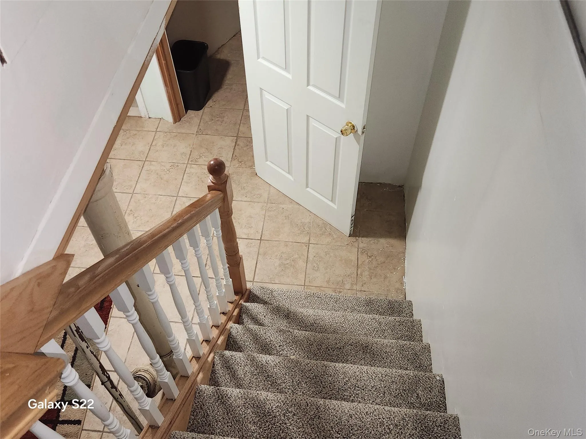 Stairs featuring tile patterned floors Stairs featuring tile patterned floors