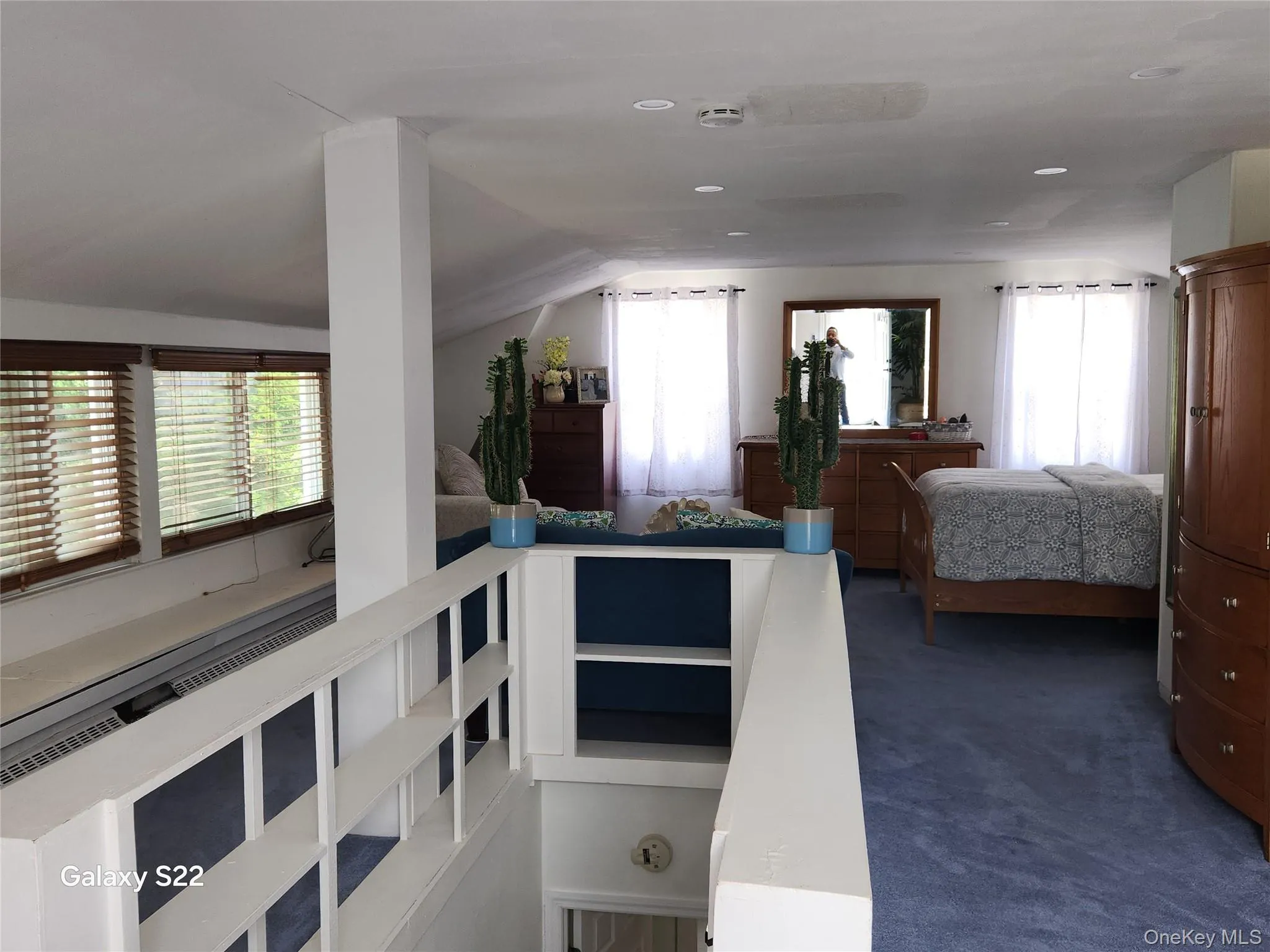 Bedroom with lofted ceiling, carpet floors, and recessed lighting Bedroom with lofted ceiling, carpet floors, and recessed lighting