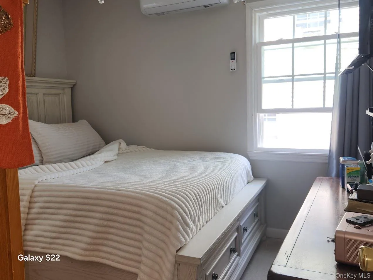 Bedroom with a wall unit AC and baseboards Bedroom with a wall unit AC and baseboards