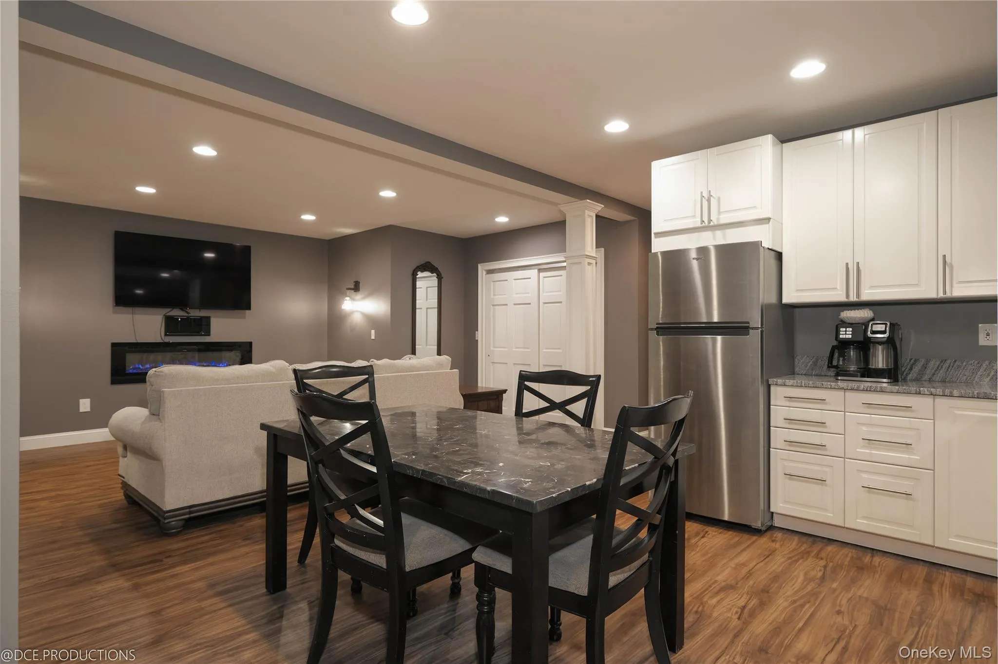 Dining space featuring wood-style flooring, recessed lighting, and is open to a lounge area. Dining space featuring wood-style flooring, recessed lighting, and is open to a lounge area.