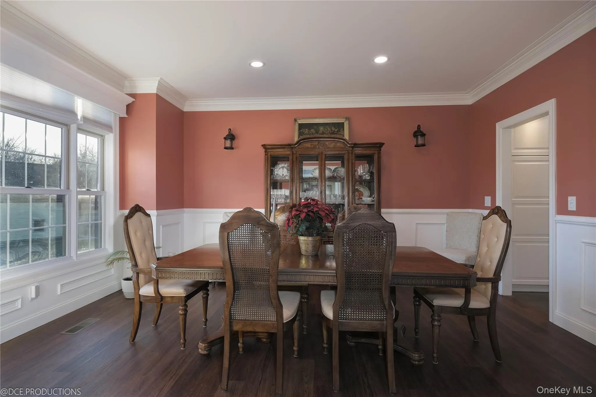 Formal dining room with great natural light, wainscoting, ornamental molding and wood finished floors Formal dining room with great natural light, wainscoting, ornamental molding and wood finished floors