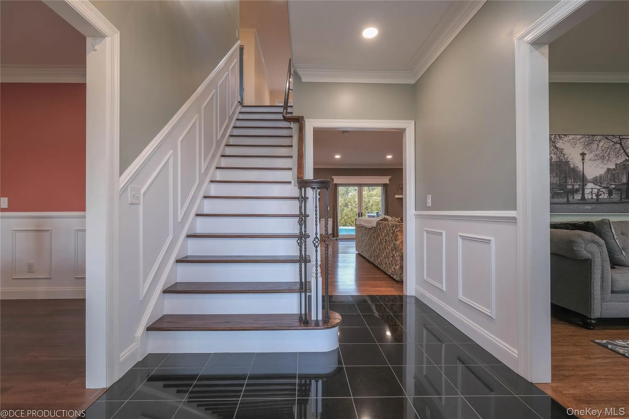 Stairway with wainscoting, crown molding and recessed lighting Stairway with wainscoting, crown molding and recessed lighting