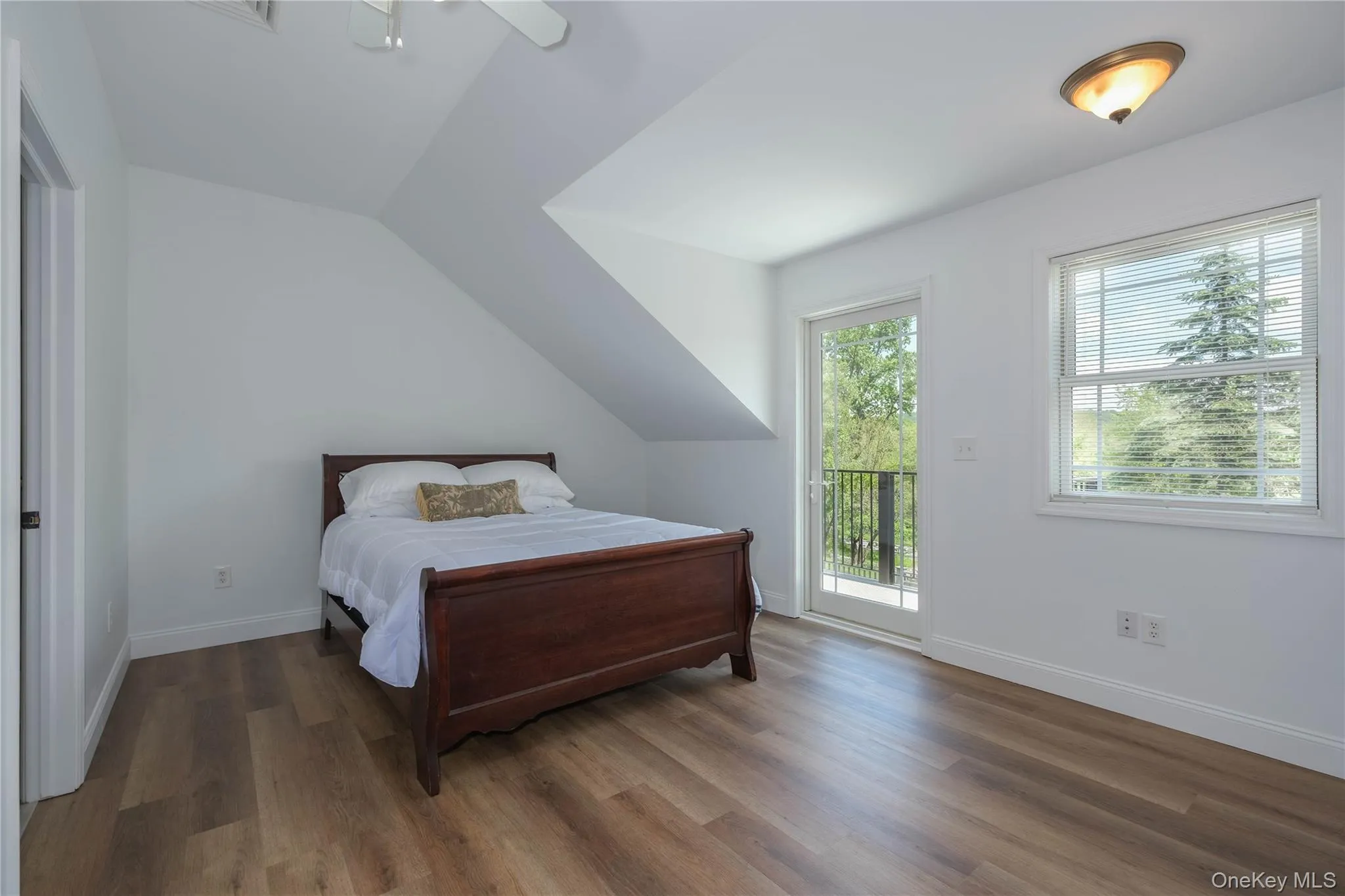 Bedroom featuring access to Juliet balcony, engineered wood flooring, high ceilings and ensuite bath. Bedroom featuring access to Juliet balcony, engineered wood flooring, high ceilings and ensuite bath.