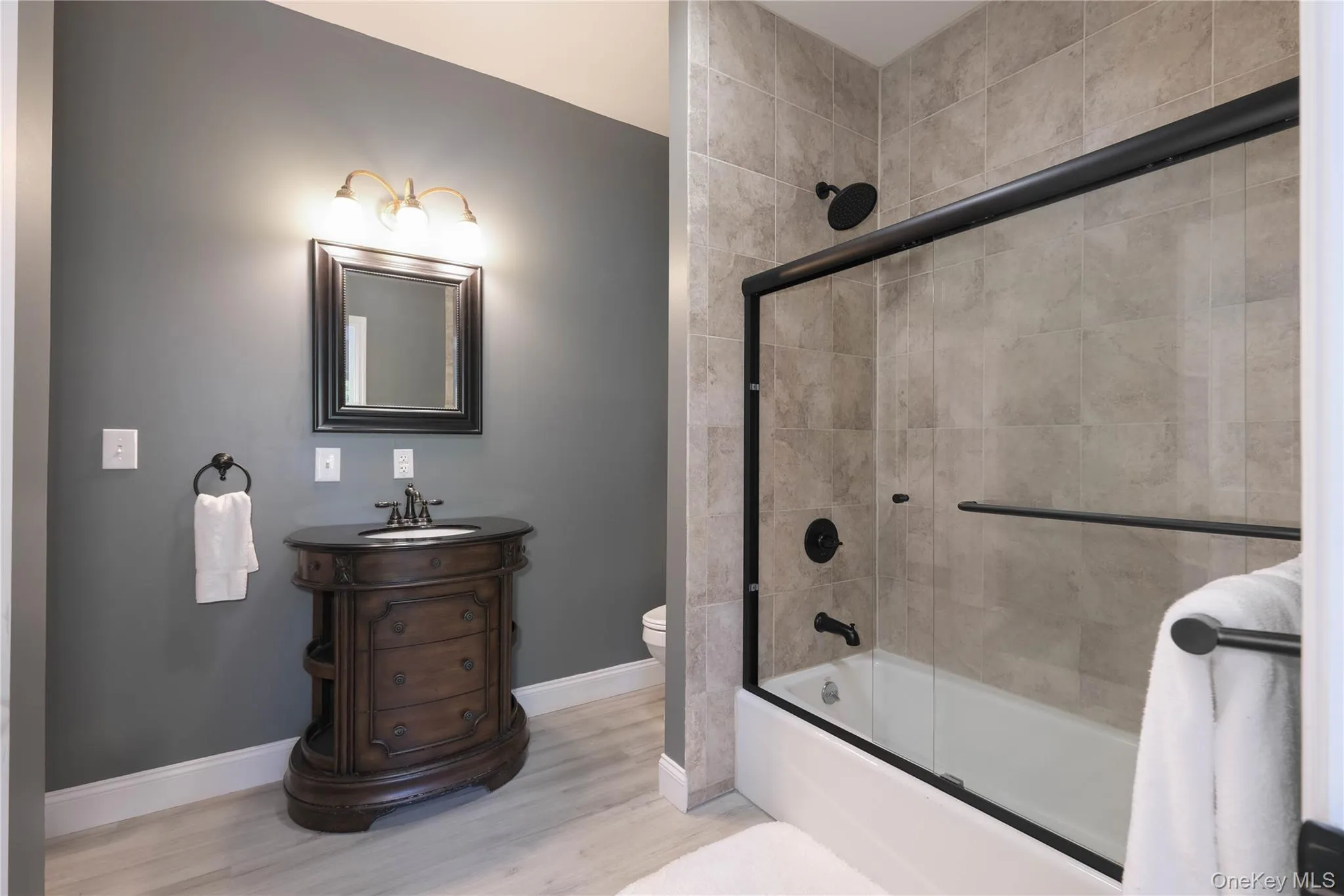 Beautiful bath with tile and glass shower/tub combo, tile flooring and chic finishes Beautiful bath with tile and glass shower/tub combo, tile flooring and chic finishes