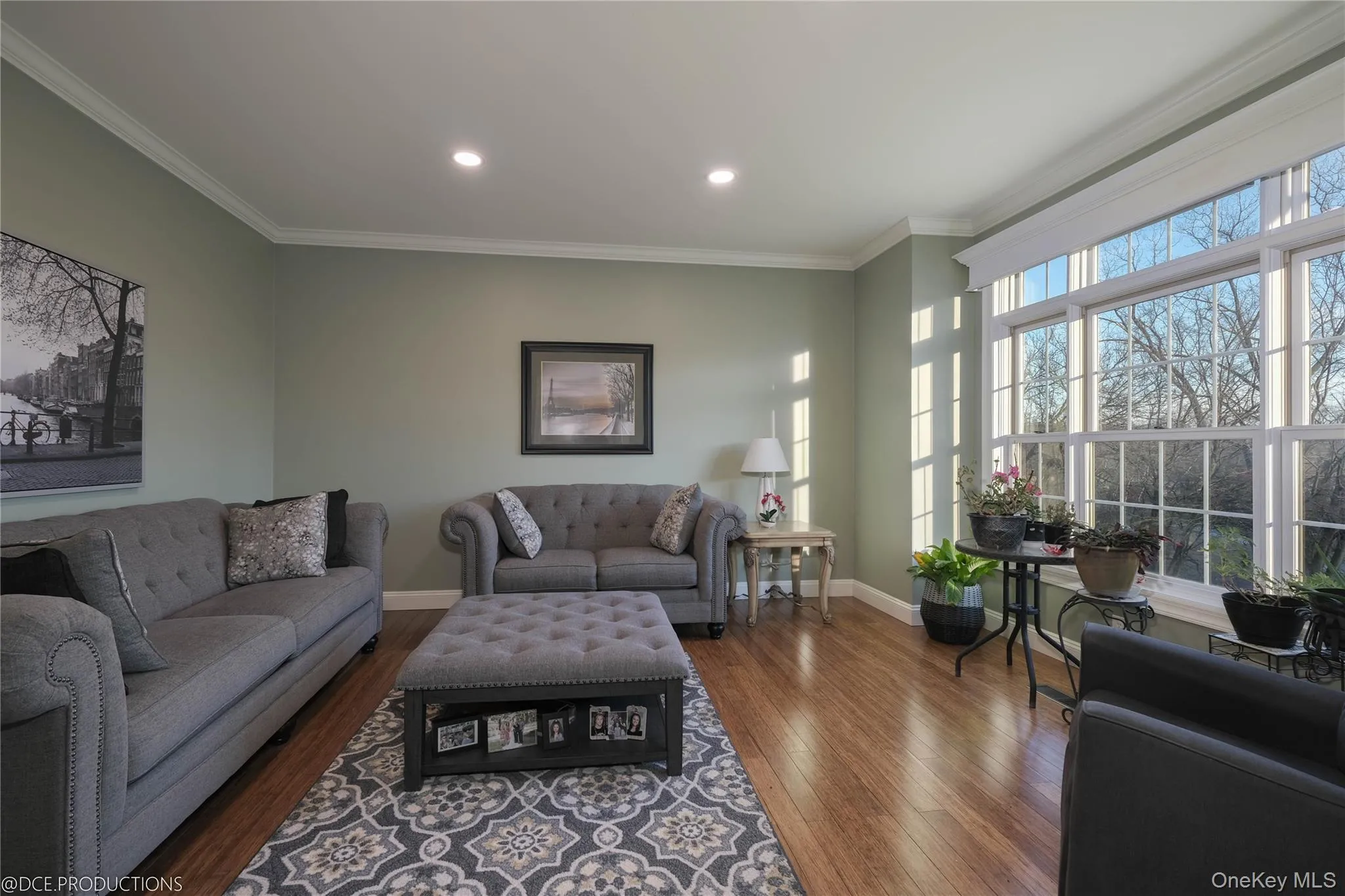 Peaceful, separate family room with hardwood flooring, ornamental crown molding, large windows and recessed lighting. Peaceful, separate family room with hardwood flooring, ornamental crown molding, large windows and recessed lighting.