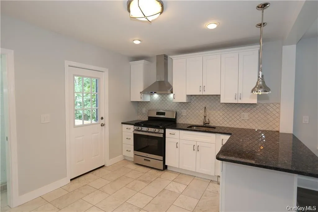 Kitchen with door leading to beautiful , private back yard Kitchen with door leading to beautiful , private back yard