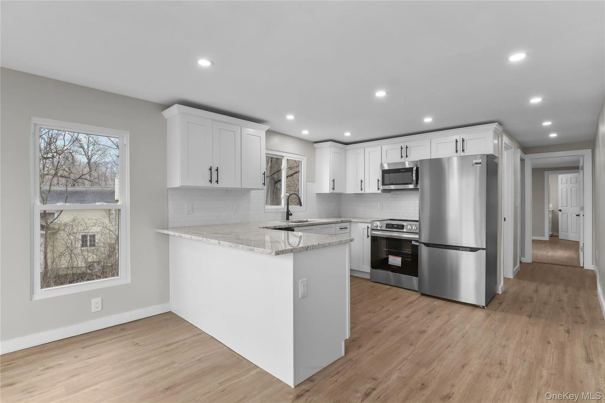 New Kitchen with White Cabinets and light granite countertops and peninsula. New Kitchen with White Cabinets and light granite countertops and peninsula.