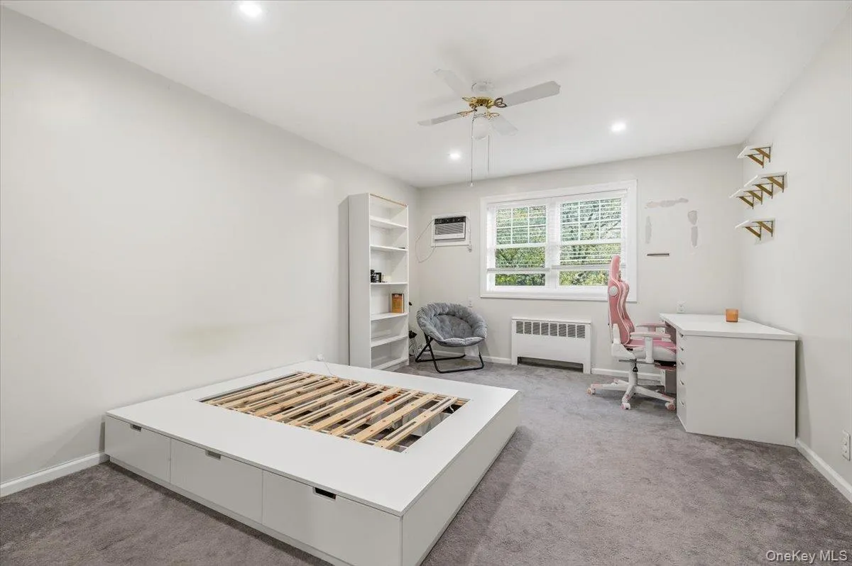 Spacious room featuring light gray walls, plush gray carpet, and recessed lighting Spacious room featuring light gray walls, plush gray carpet, and recessed lighting