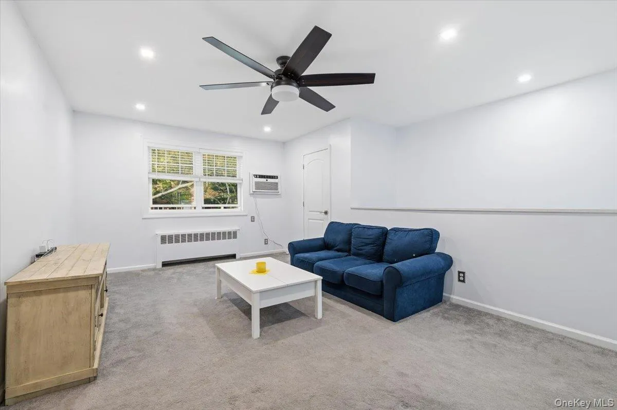 Recessed lighting illuminates this room featuring wall-to-wall carpeting and a ceiling fan Recessed lighting illuminates this room featuring wall-to-wall carpeting and a ceiling fan
