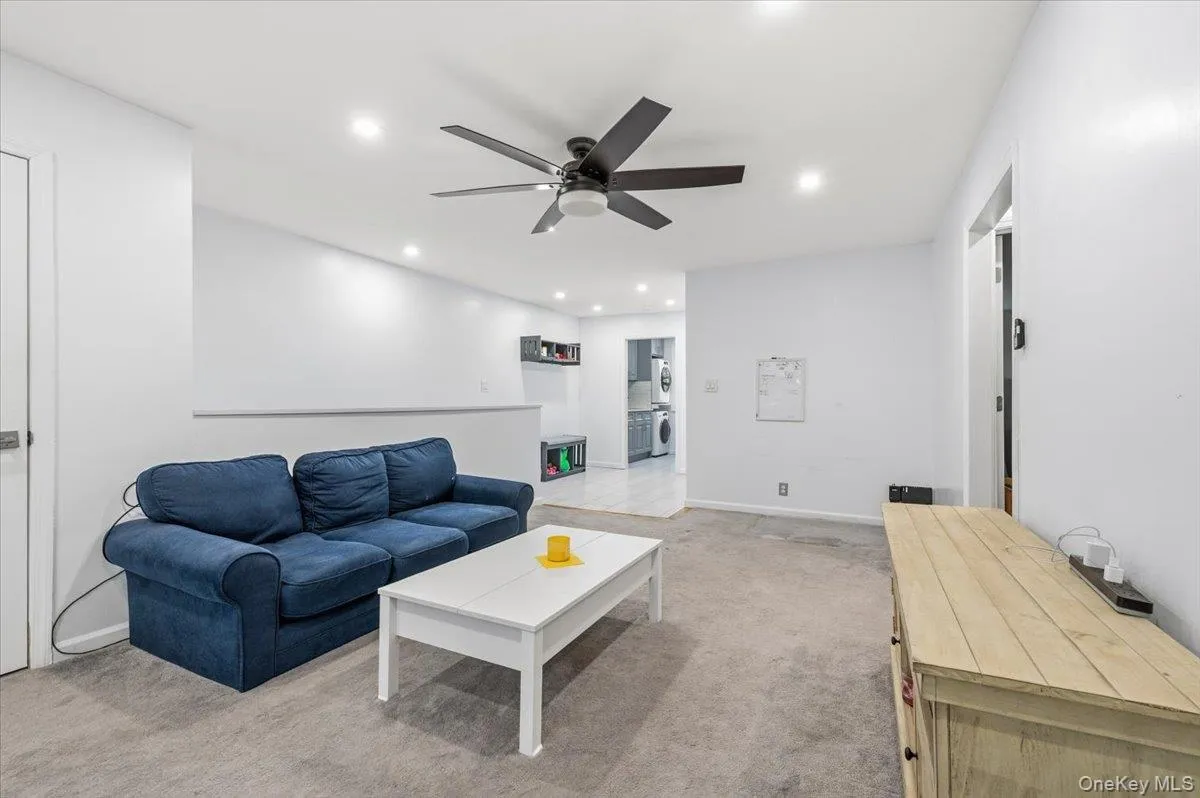 Spacious room featuring light gray carpeting and white walls Spacious room featuring light gray carpeting and white walls