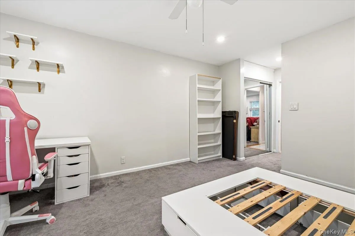 Spacious room featuring neutral wall tones, grey carpeting, recessed lighting, and a ceiling fan Spacious room featuring neutral wall tones, grey carpeting, recessed lighting, and a ceiling fan