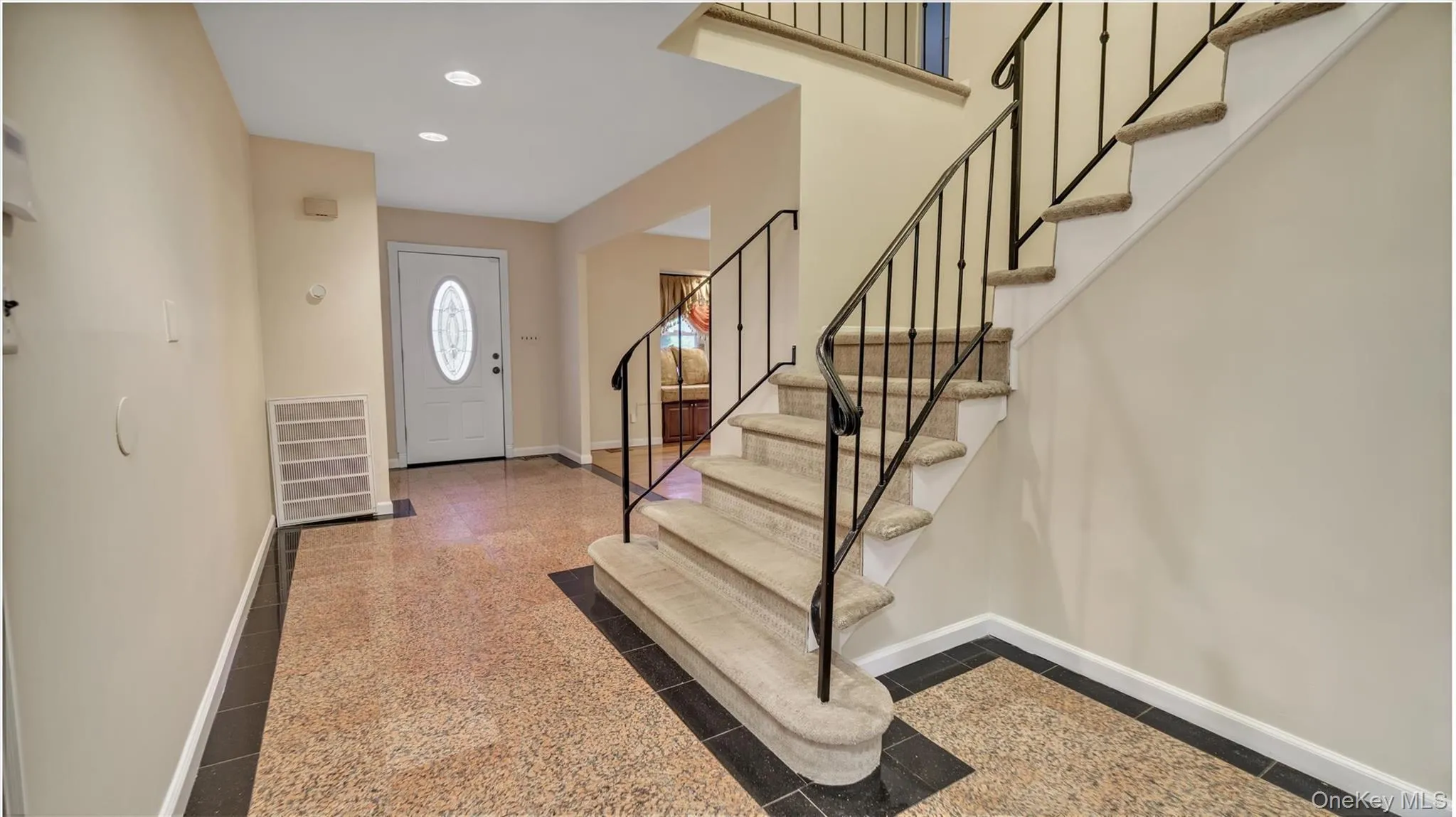 Foyer with visible vents, baseboards, stairway, and granite finish floor Foyer with visible vents, baseboards, stairway, and granite finish floor