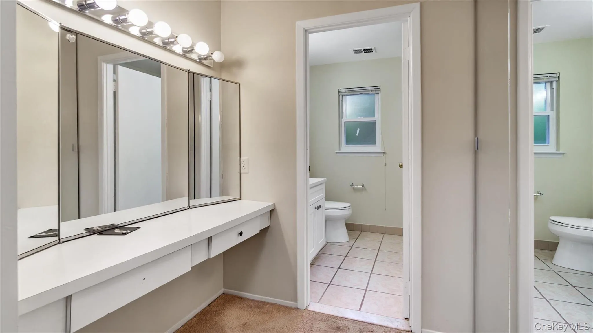 Bathroom with toilet, visible vents, tile patterned flooring, and baseboards Bathroom with toilet, visible vents, tile patterned flooring, and baseboards