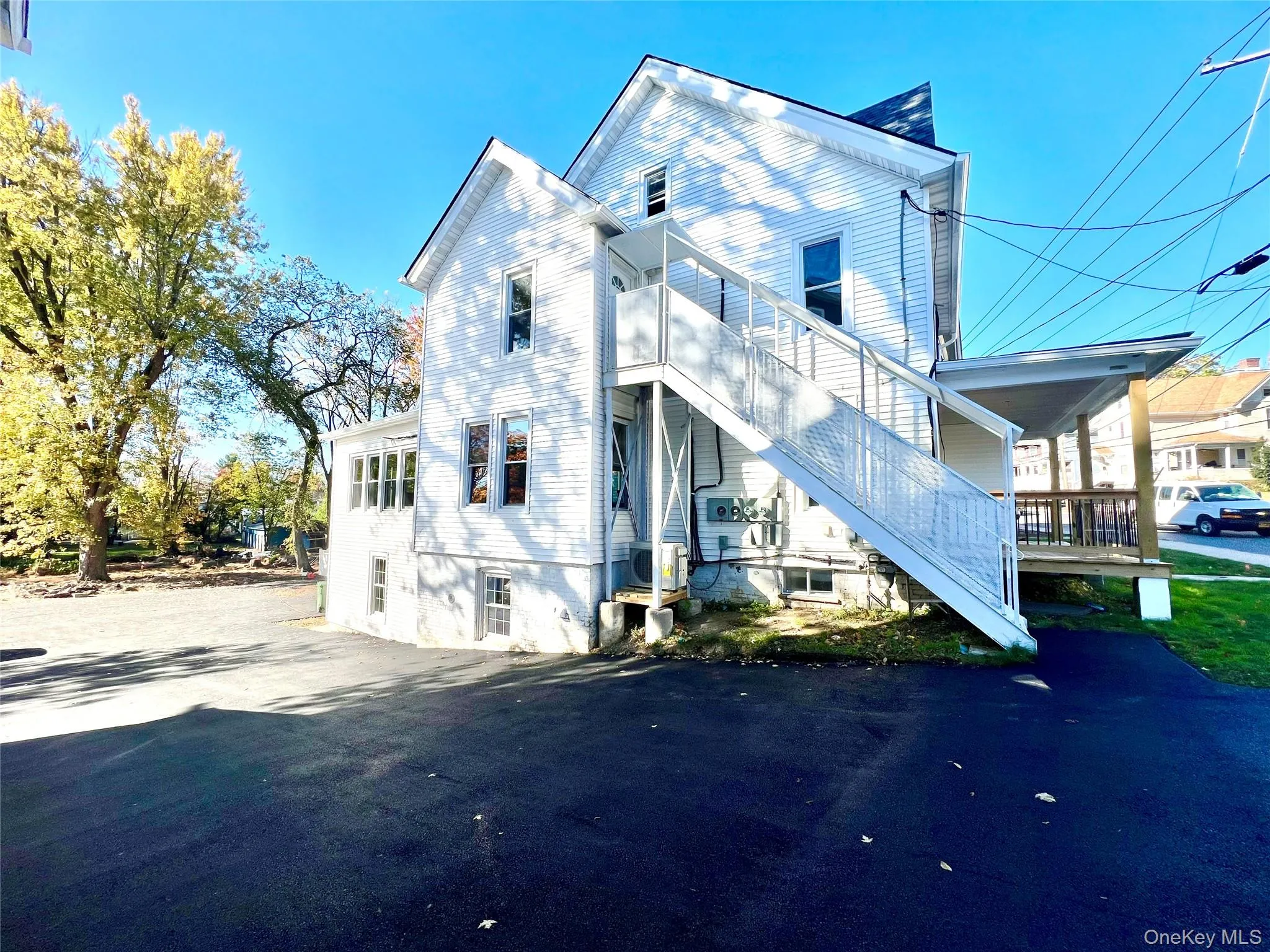 Back of house with stairway Back of house with stairway