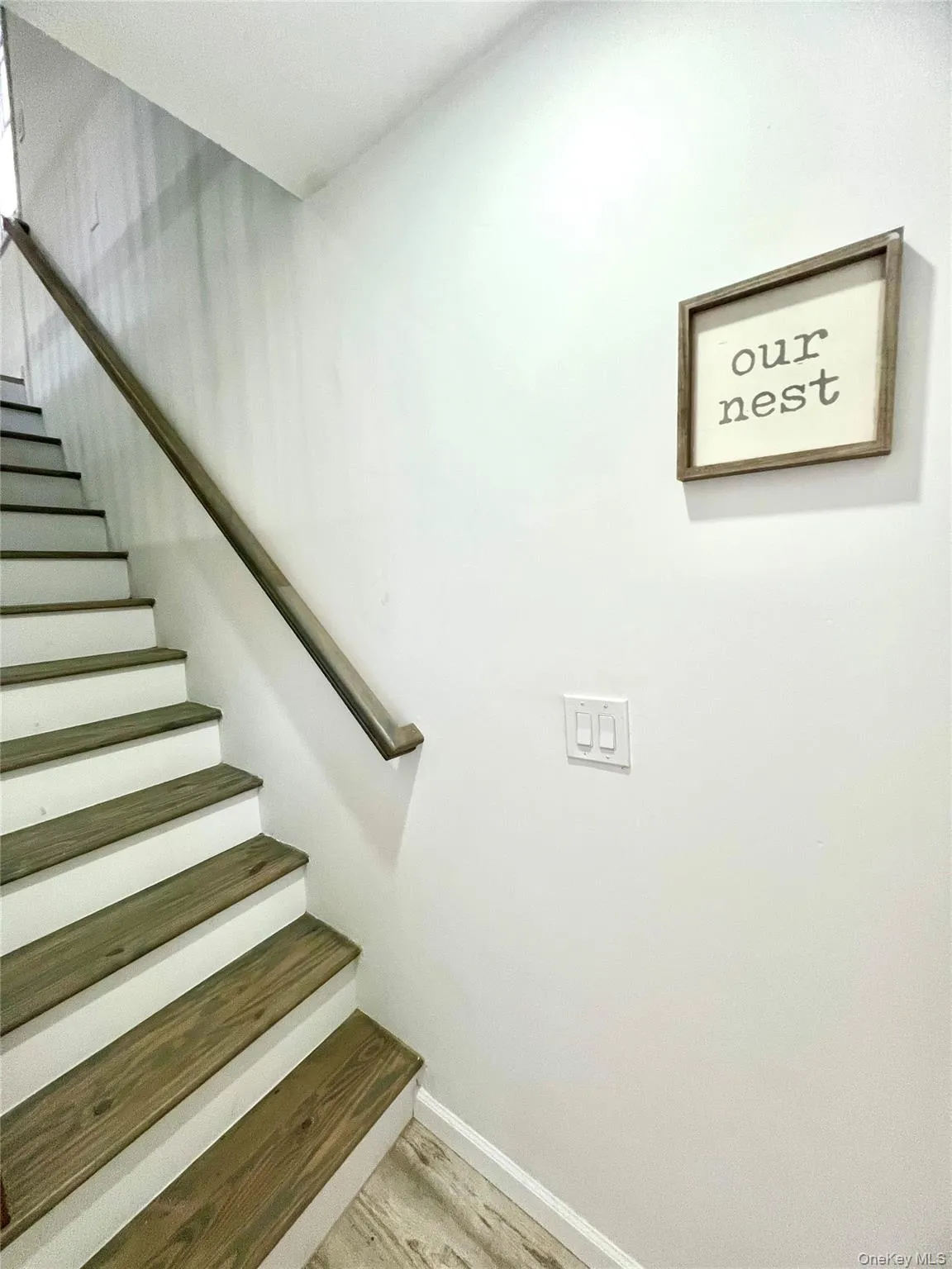 Stairway featuring wood finished floors and baseboards Stairway featuring wood finished floors and baseboards