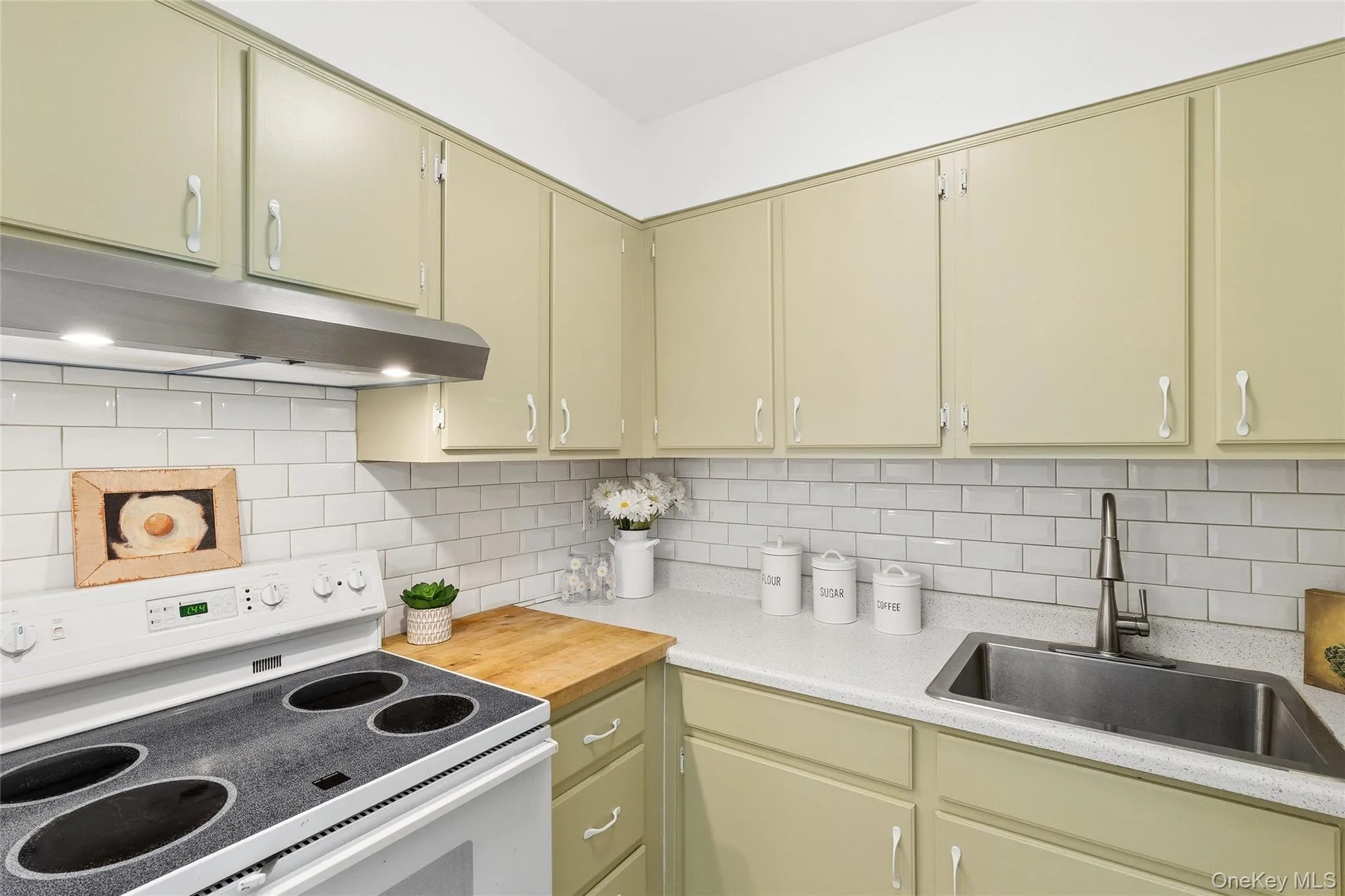 Freshly painted kitchen, subway tile backsplash, built in butcher block cutting board & deep stainless steel sink Freshly painted kitchen, subway tile backsplash, built in butcher block cutting board & deep stainless steel sink