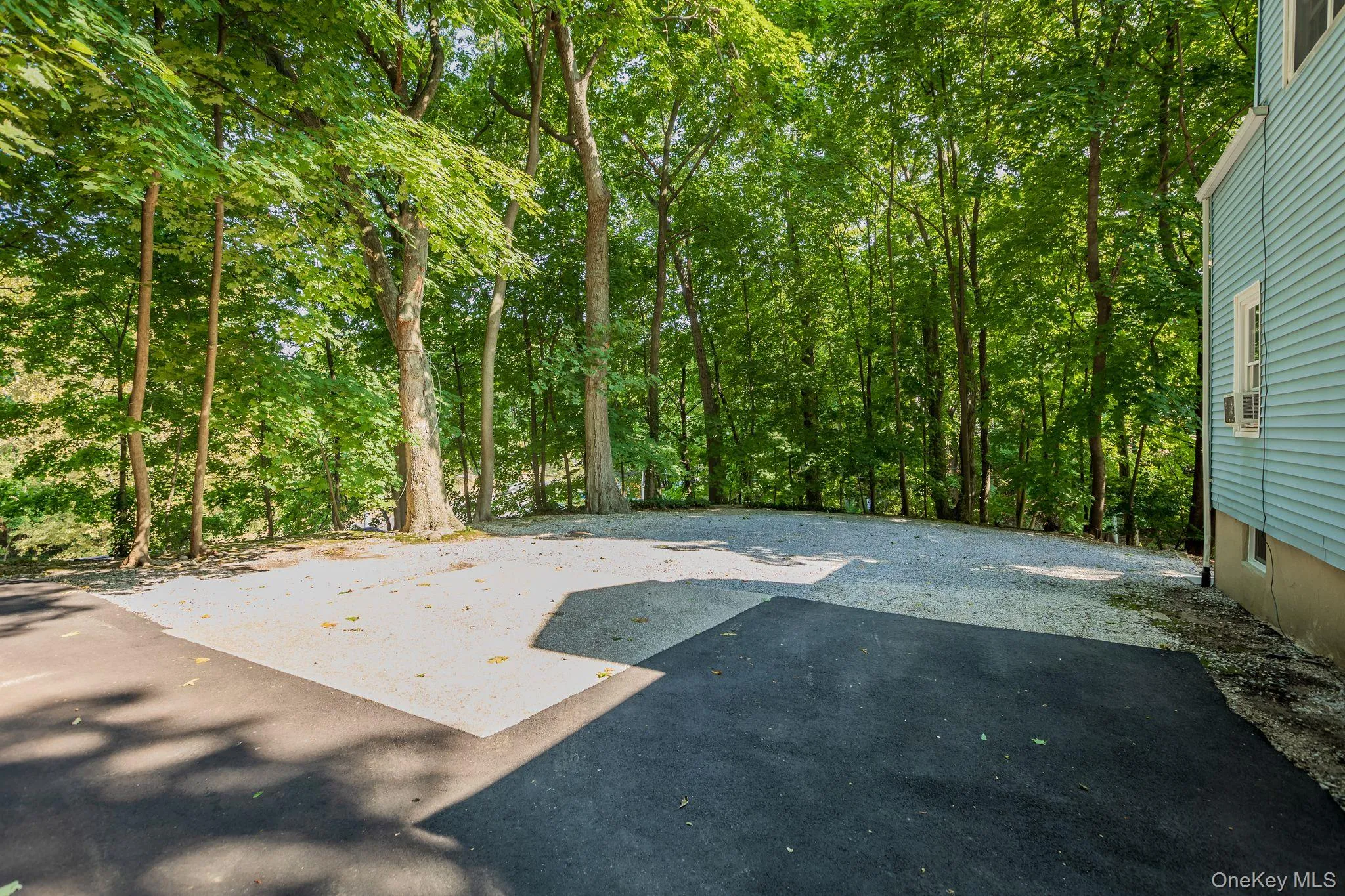 Large parking area located at the rear of the home Large parking area located at the rear of the home