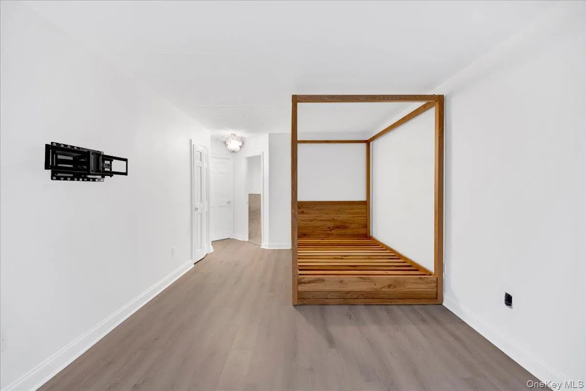 Hallway featuring light wood-style flooring and baseboards Hallway featuring light wood-style flooring and baseboards