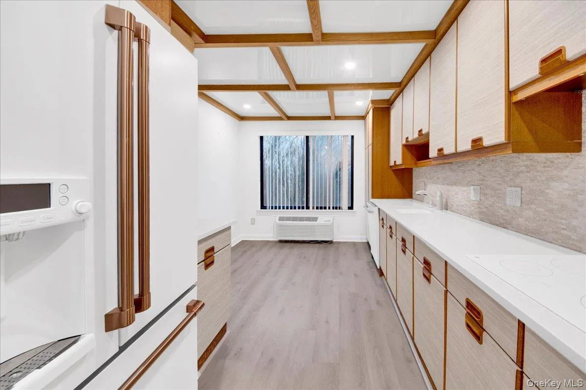 Dual tone Eat-in kitchen with white stainless steel appliances, dual tone cabinets, light wood-style floors, coffered ceiling, and recessed lighting Dual tone Eat-in kitchen with white stainless steel appliances, dual tone cabinets, light wood-style floors, coffered ceiling, and recessed lighting