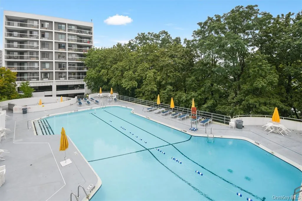 Community pool with a patio area Community pool with a patio area