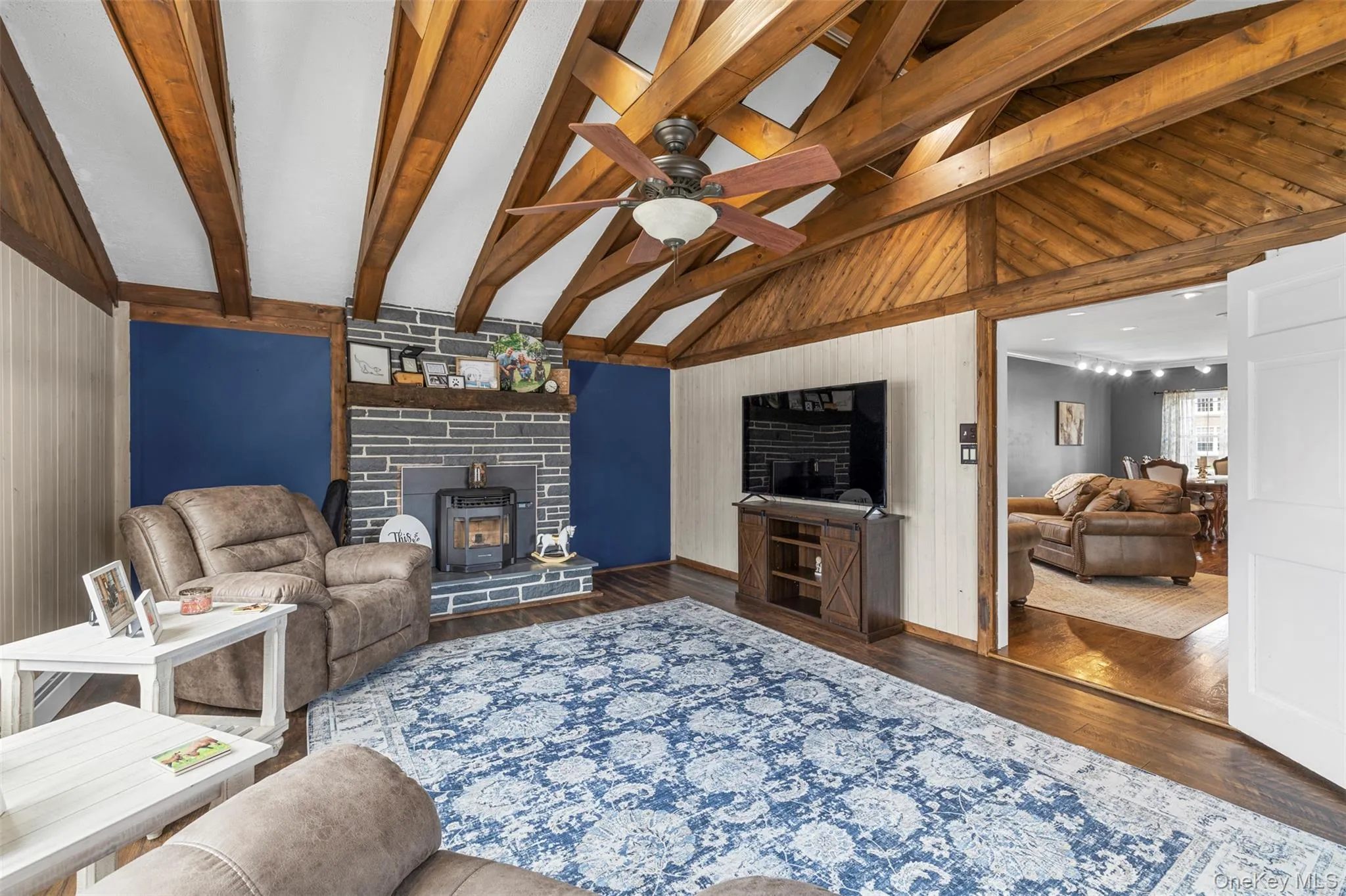 Featuring vaulted ceilings with wood beams and fireplace with mantel Featuring vaulted ceilings with wood beams and fireplace with mantel