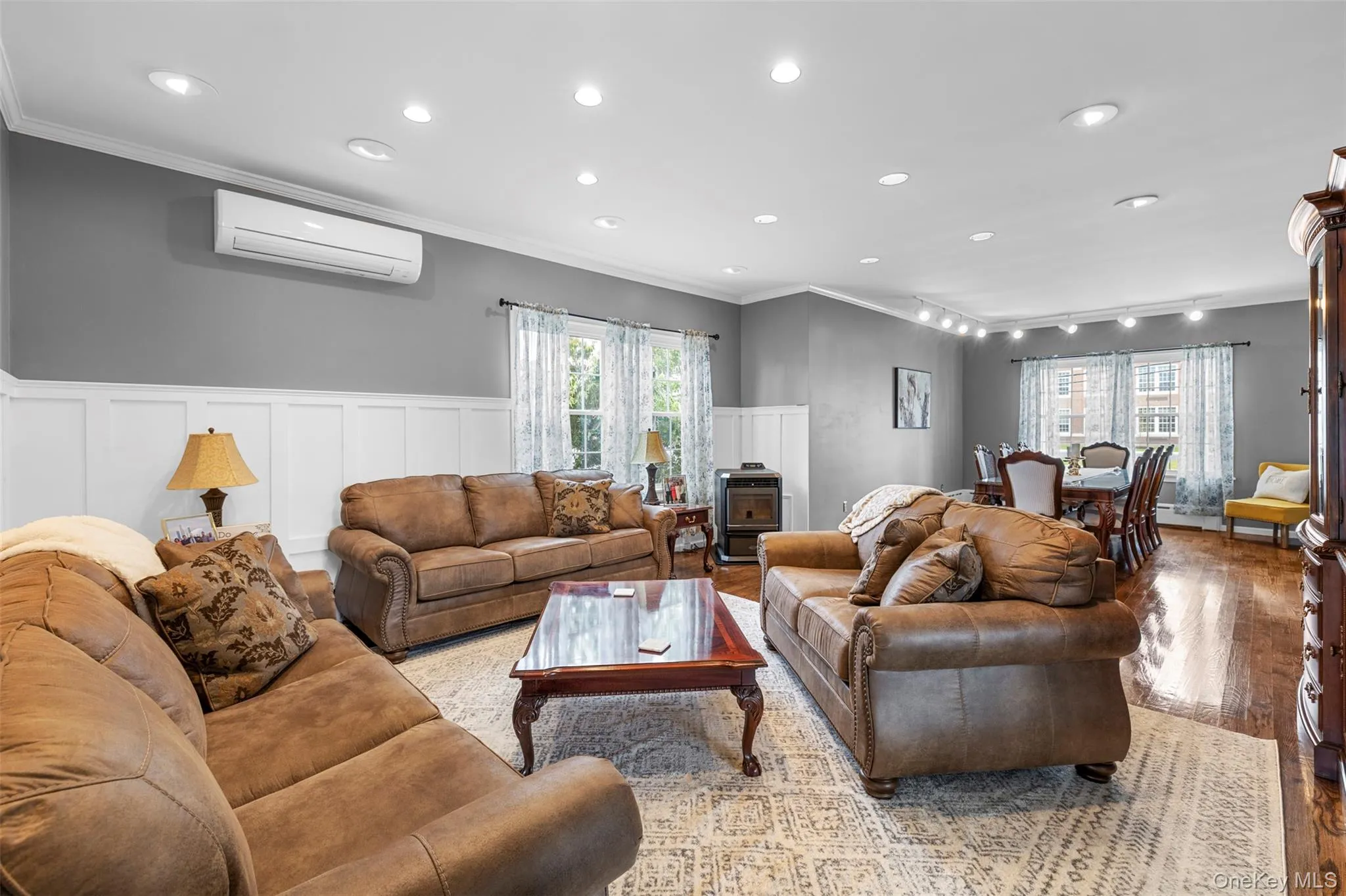 Formal living area with crown molding, wood finished floors, wainscoting, and recessed lighting Formal living area with crown molding, wood finished floors, wainscoting, and recessed lighting
