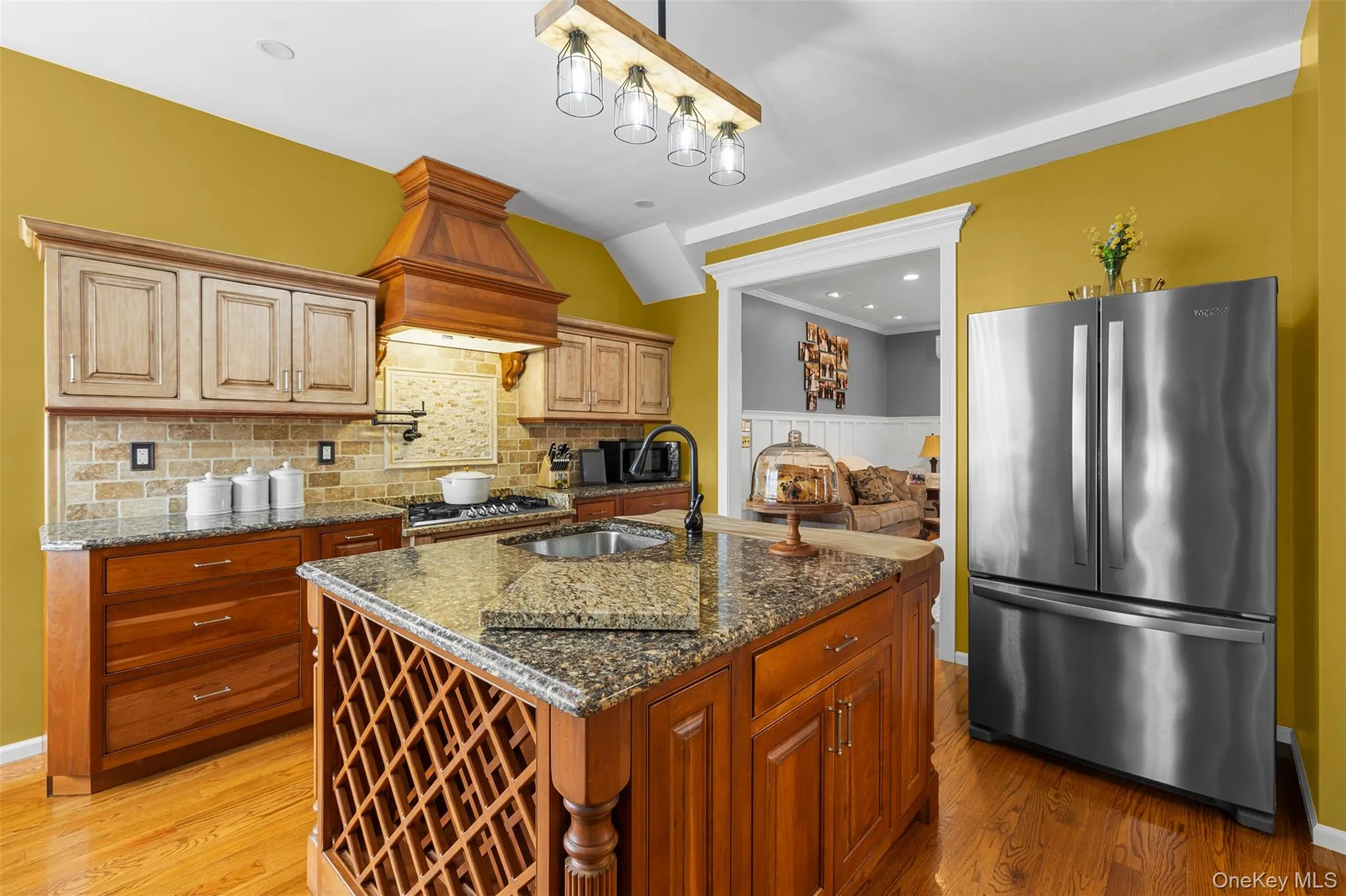 Kitchen with center island, eating nook, stainless steel appliances and pot filler Kitchen with center island, eating nook, stainless steel appliances and pot filler