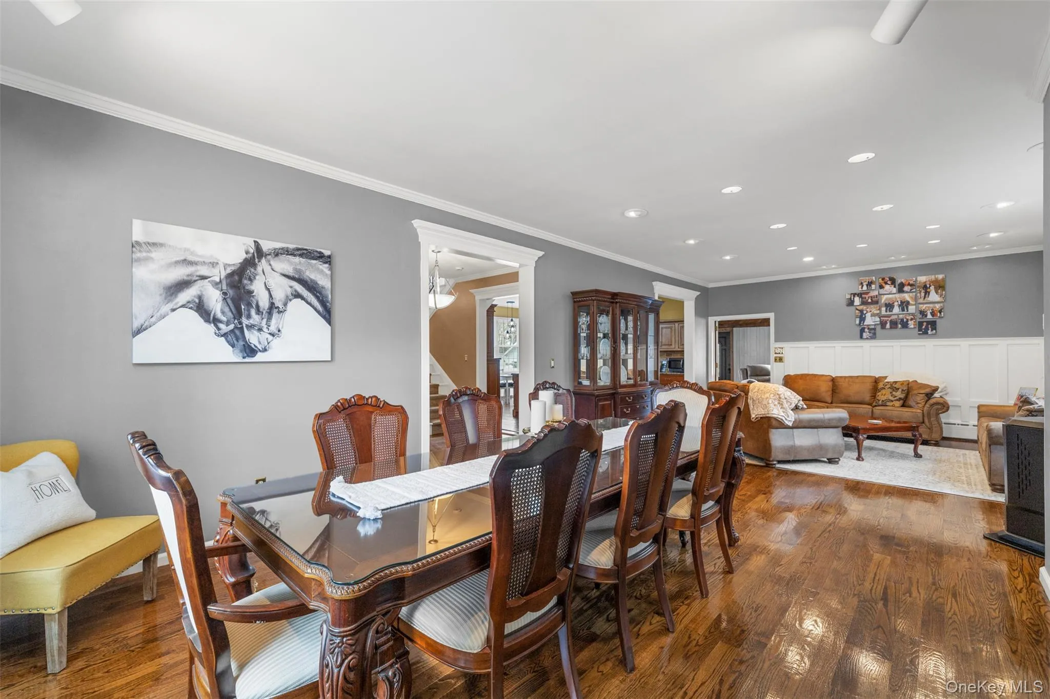 Formal dining room with wood finished floors, rail lighting, and crown molding Formal dining room with wood finished floors, rail lighting, and crown molding
