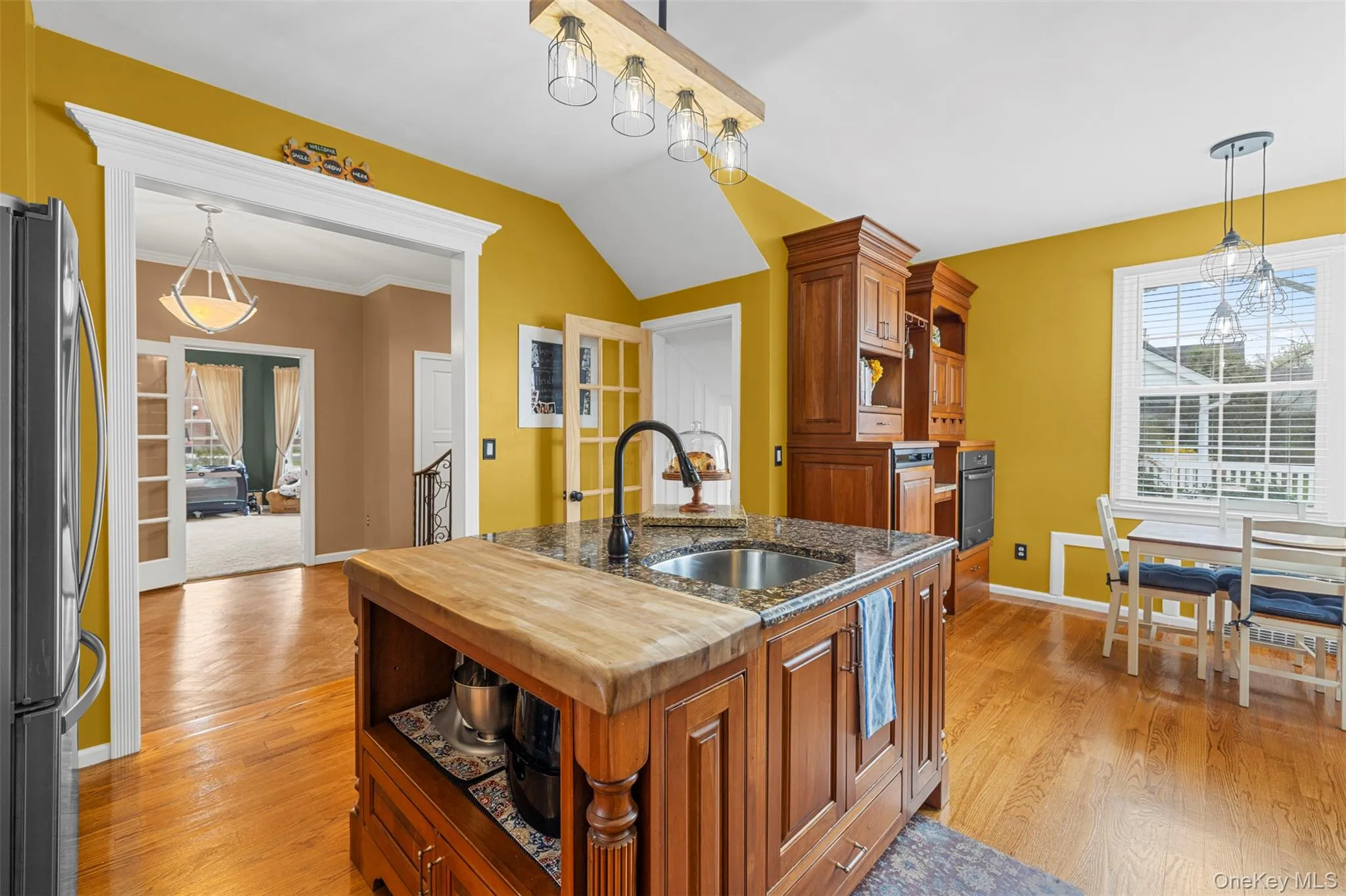 Kitchen with center island, eating nook, stainless steel appliances and pot filler Kitchen with center island, eating nook, stainless steel appliances and pot filler