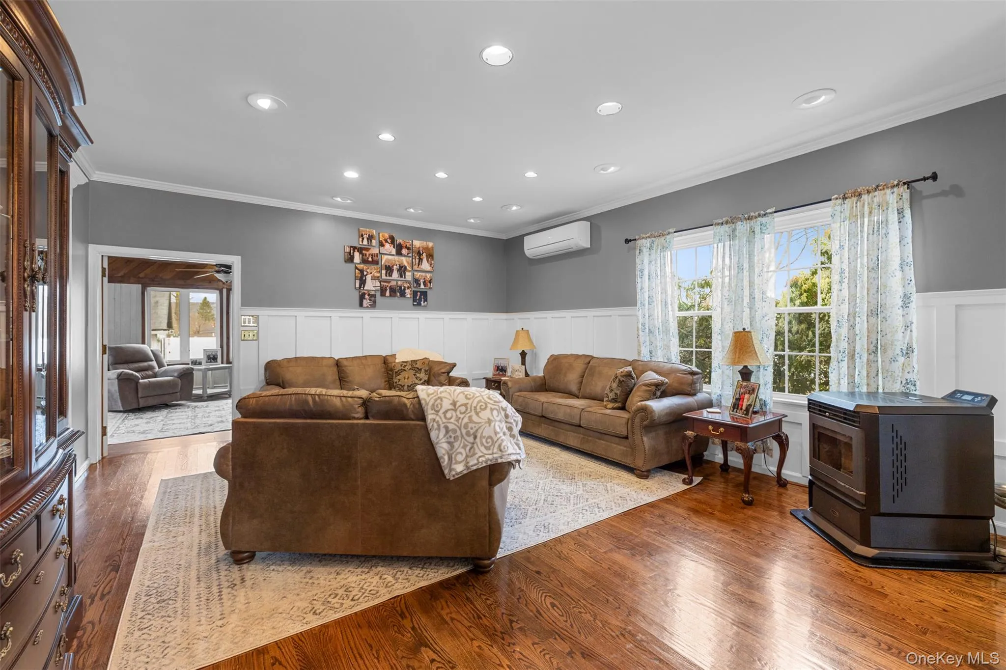 Formal living area with crown molding, wood finished floors, wainscoting, and recessed lighting Formal living area with crown molding, wood finished floors, wainscoting, and recessed lighting