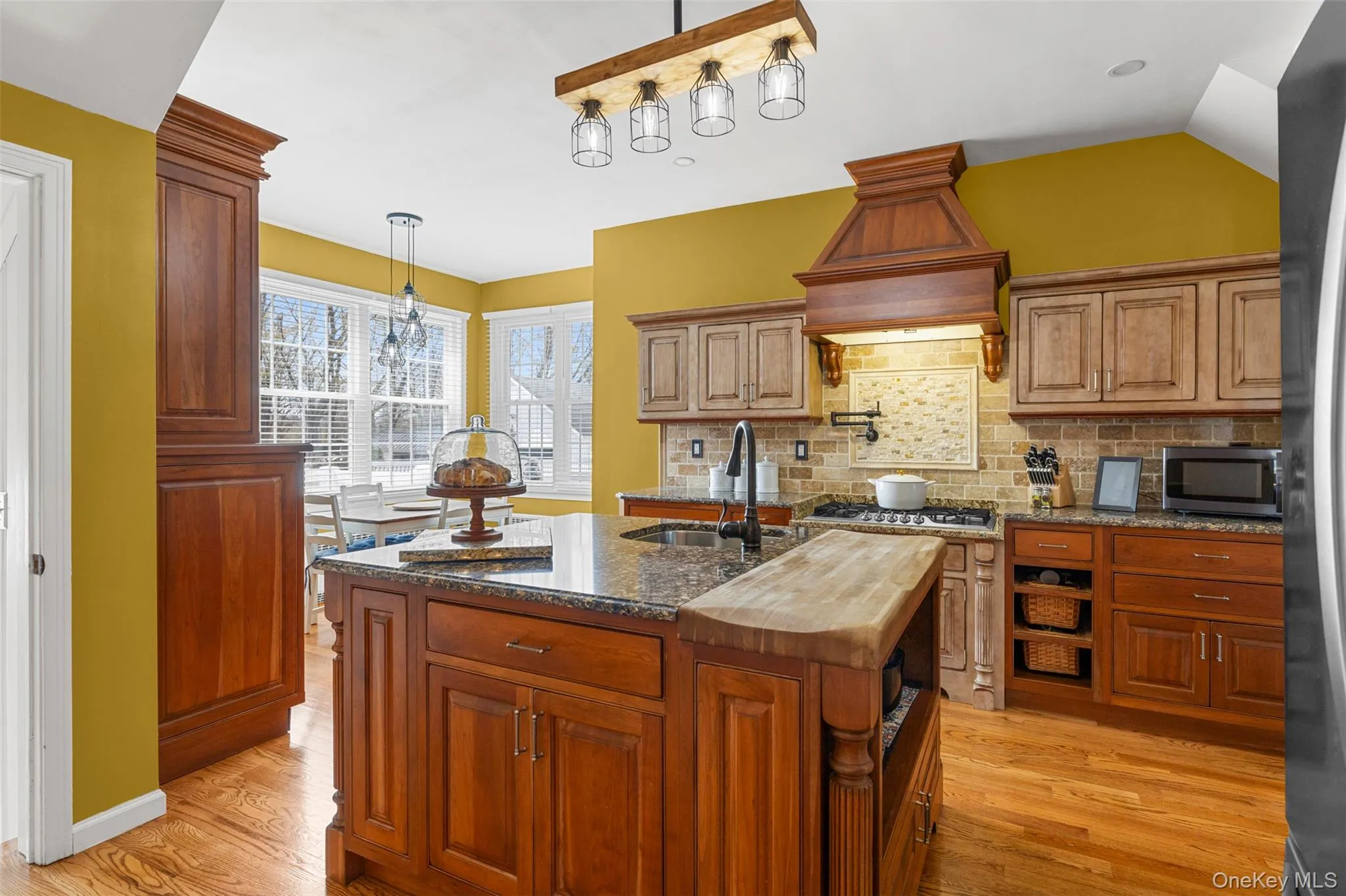 Kitchen with center island, eating nook, stainless steel appliances and pot filler Kitchen with center island, eating nook, stainless steel appliances and pot filler