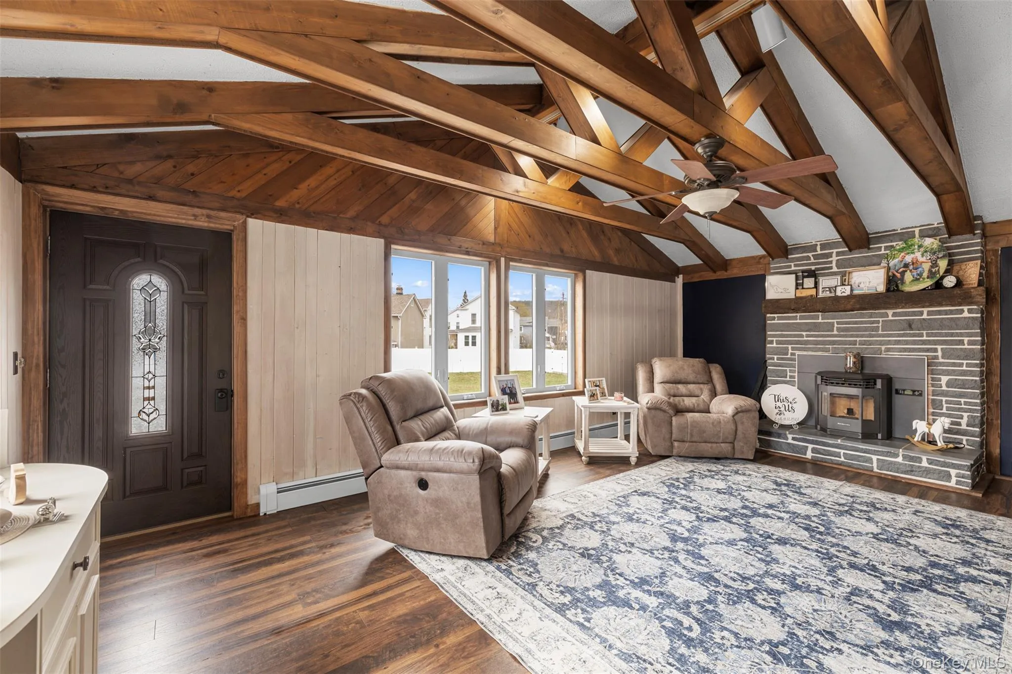 Featuring vaulted ceilings with wood beams and fireplace with mantel Featuring vaulted ceilings with wood beams and fireplace with mantel