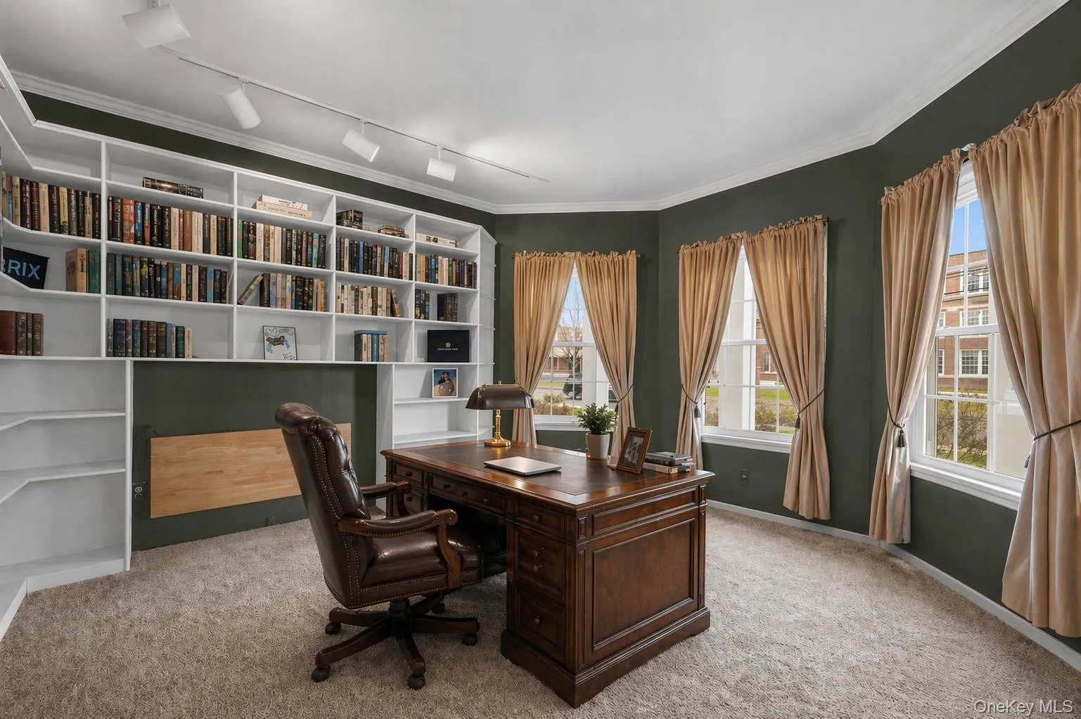 Library/office space with built in shelving, carpeted floors, and crown molding. Virtually staged for furniture. Library/office space with built in shelving, carpeted floors, and crown molding. Virtually staged for furniture.