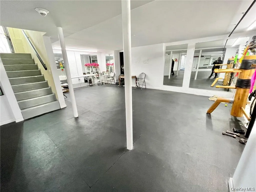 Finished below grade area with stairway and rubber floors Finished below grade area with stairway and rubber floors