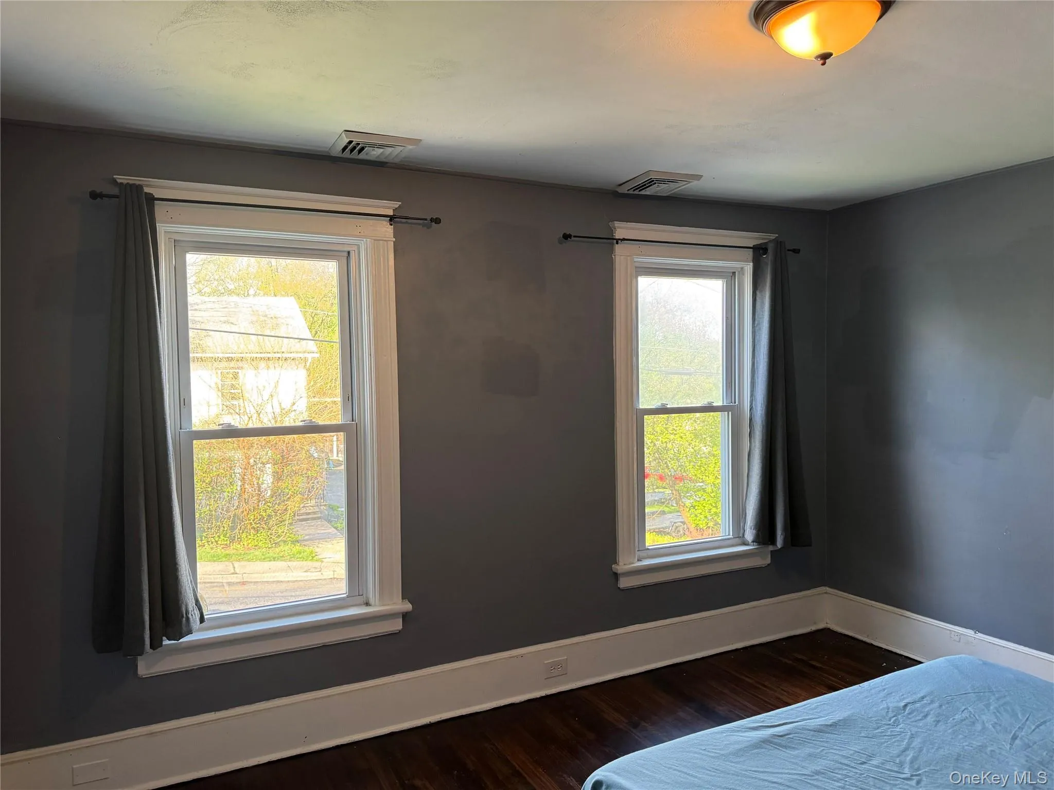 Dark wood-finish flooring complemented by white trim and a neutral wall color Dark wood-finish flooring complemented by white trim and a neutral wall color