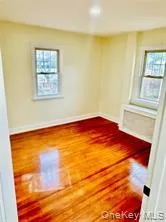 Empty room with wood finished floors and baseboards Empty room with wood finished floors and baseboards