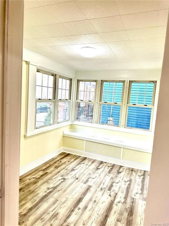 Unfurnished sunroom featuring radiator heating unit Unfurnished sunroom featuring radiator heating unit