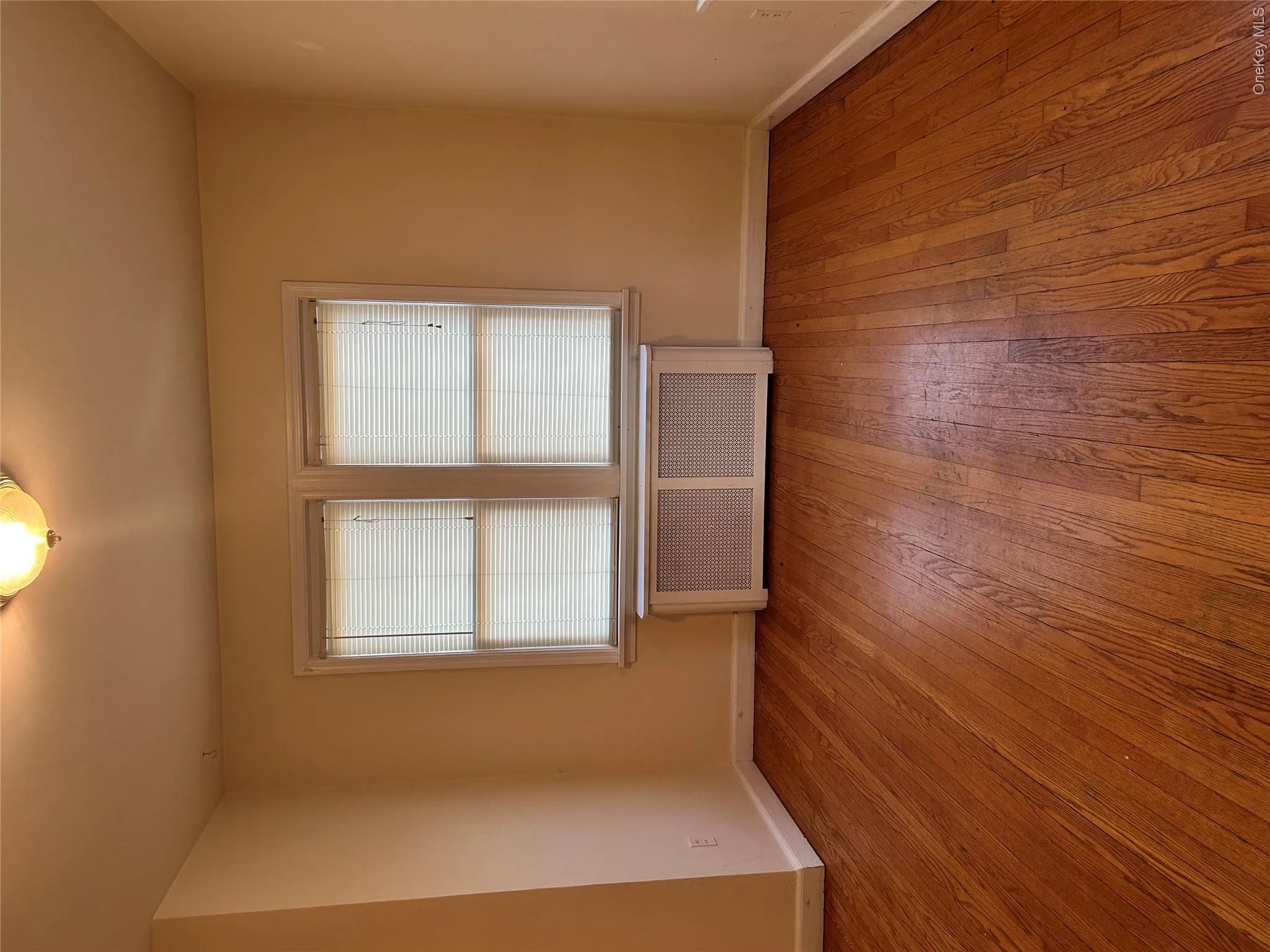 Empty room with radiator and light wood-type flooring Empty room with radiator and light wood-type flooring