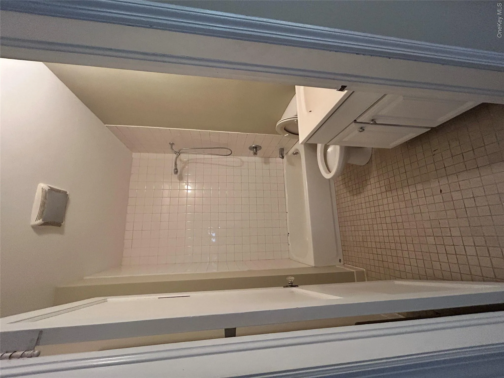 Full bath with vanity, tub / shower combination, and light tile patterned floors Full bath with vanity, tub / shower combination, and light tile patterned floors