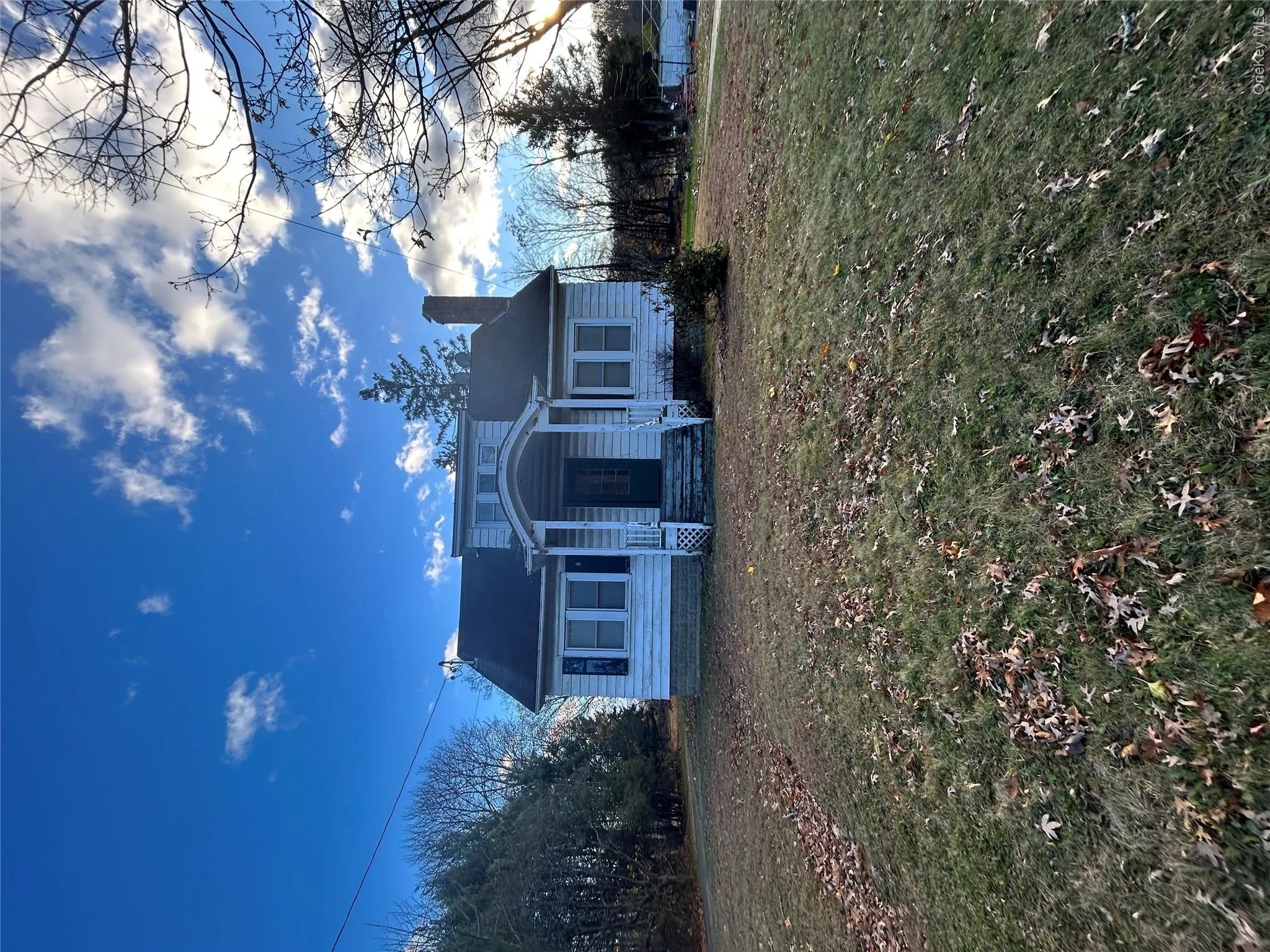 View of front of house featuring a front yard and a chimney View of front of house featuring a front yard and a chimney
