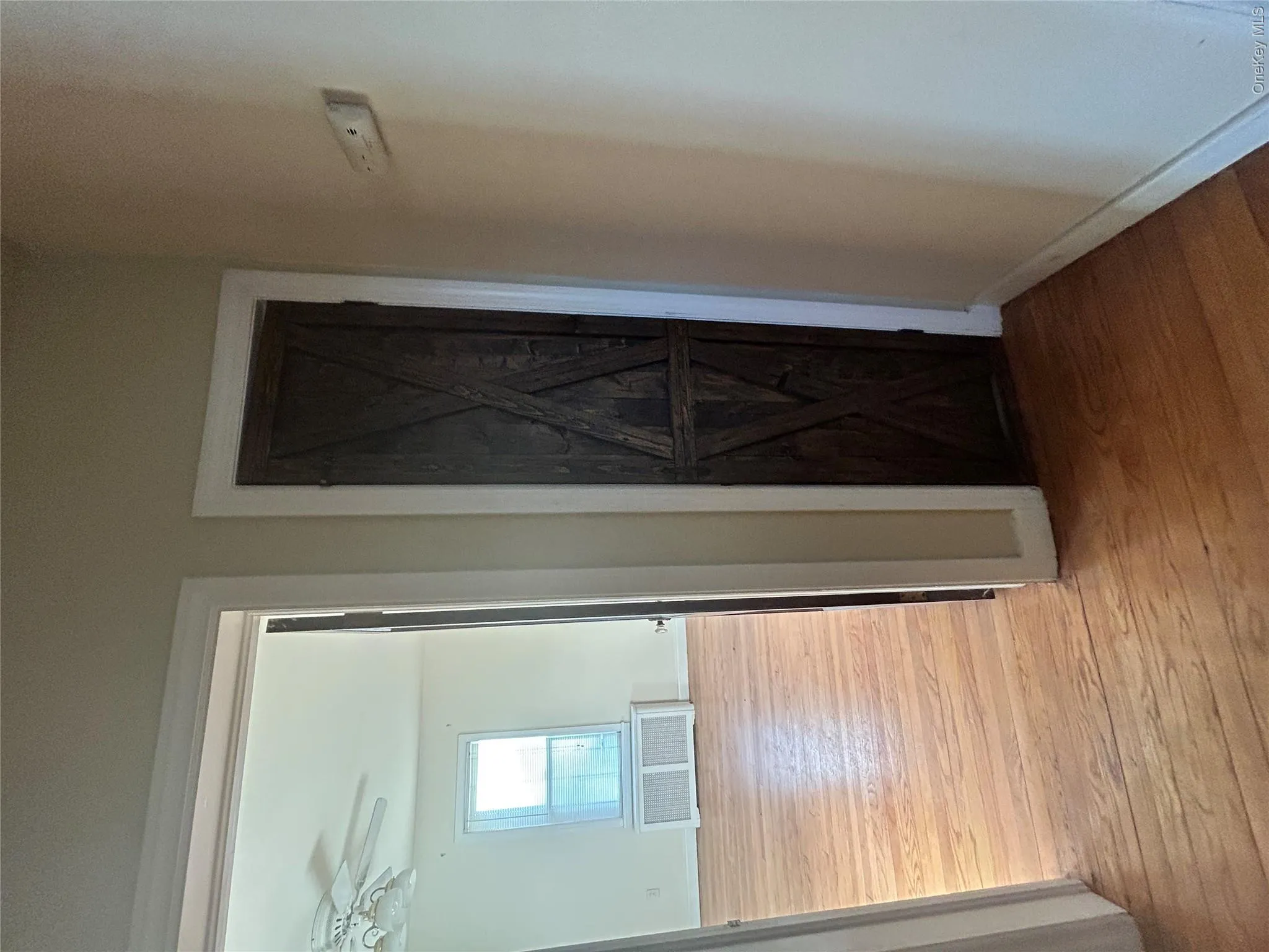 Hallway featuring light wood-style floors Hallway featuring light wood-style floors